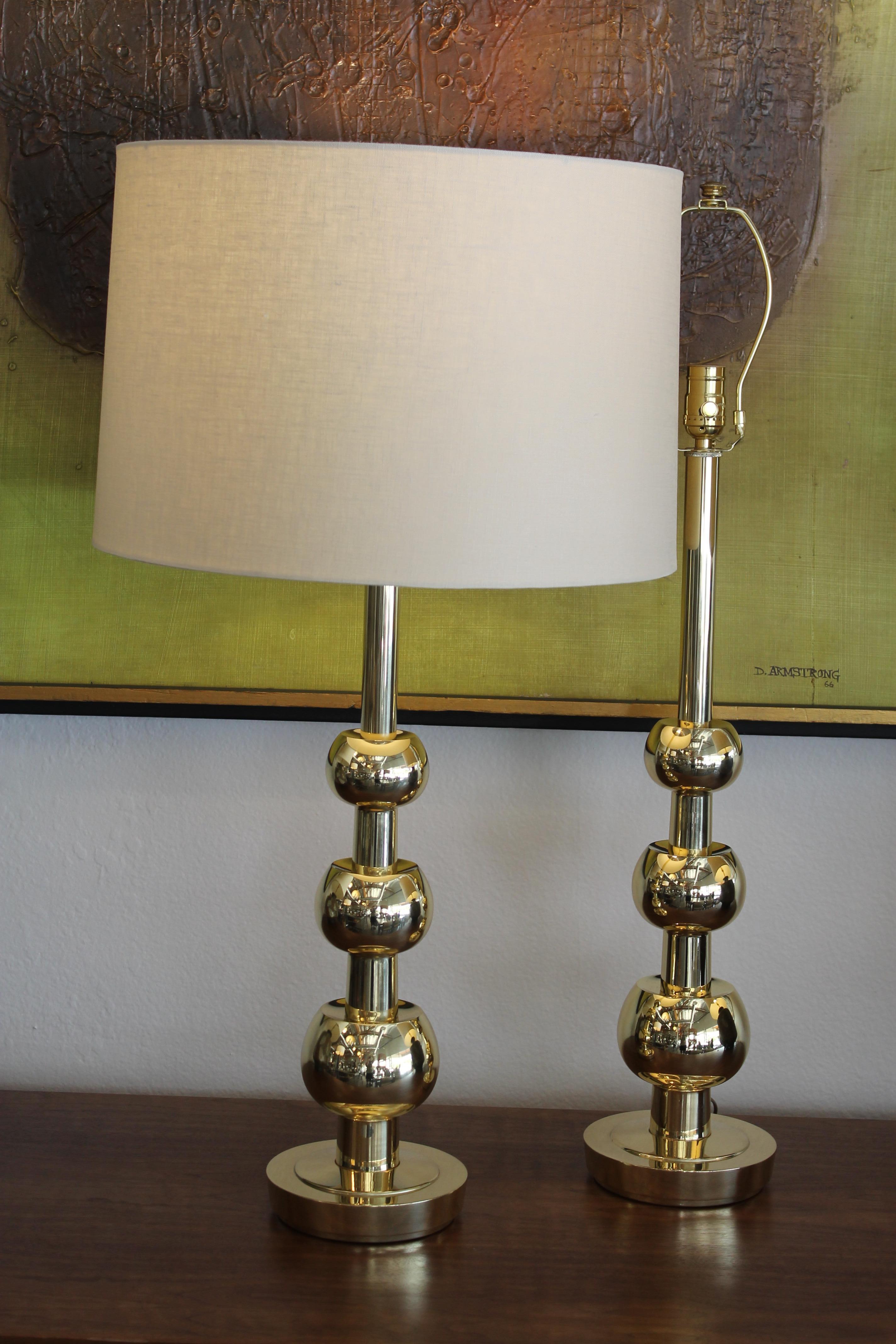 Brass table lamps by Stiffel, circa 1960s. Lamps were originally a faded brass and we had them re-brassed and a clear coat applied so, finger prints won't show up.  Lamps are professionally rewired. Total height from base to the top of socket is