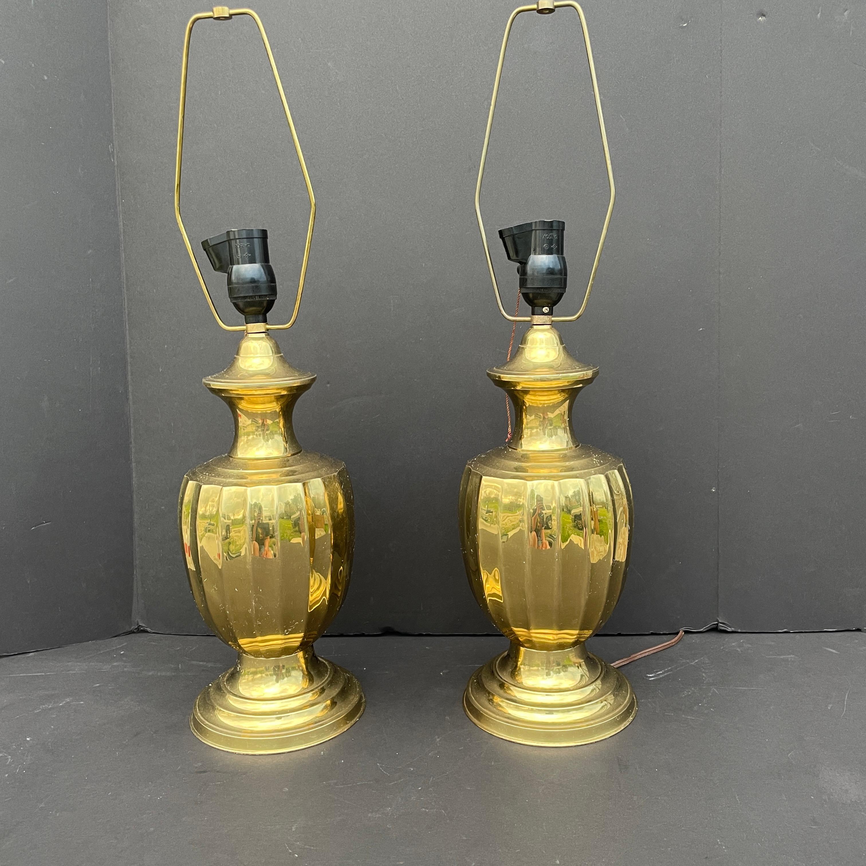 Genuine vintage pair of brass lamps attributed to Frederick Cooper. Polished and then lacquered will make these babies have a rich golden shine for many years to come. Lamps are fitted with a double light bulb allowing you more or less light as