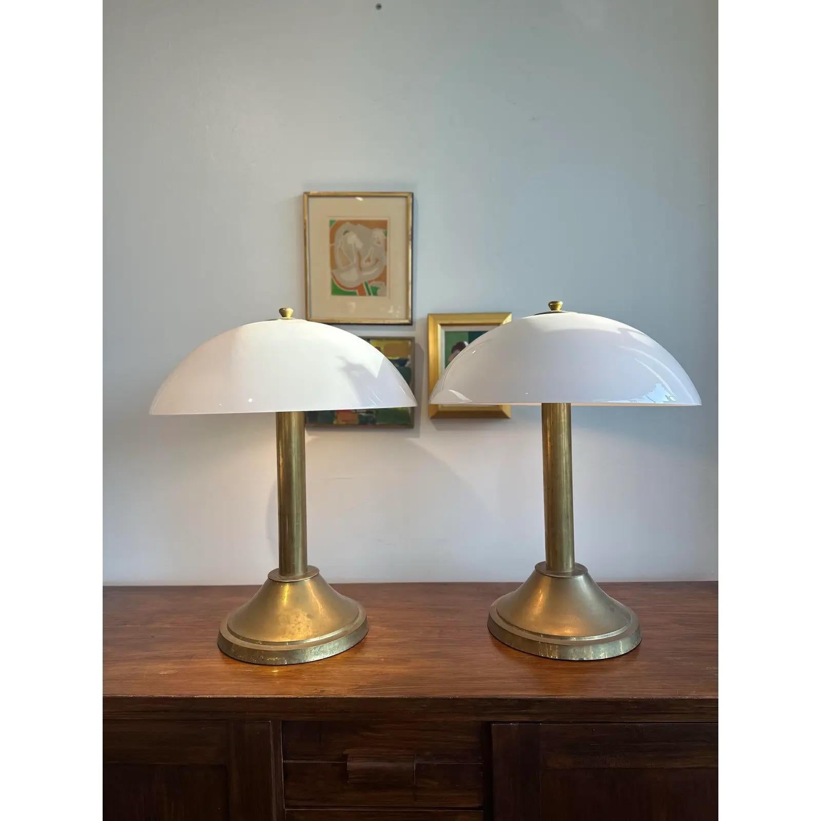 Art Deco period brass lamps. Beautiful spherical glass lampshades to match. Solid and classic.