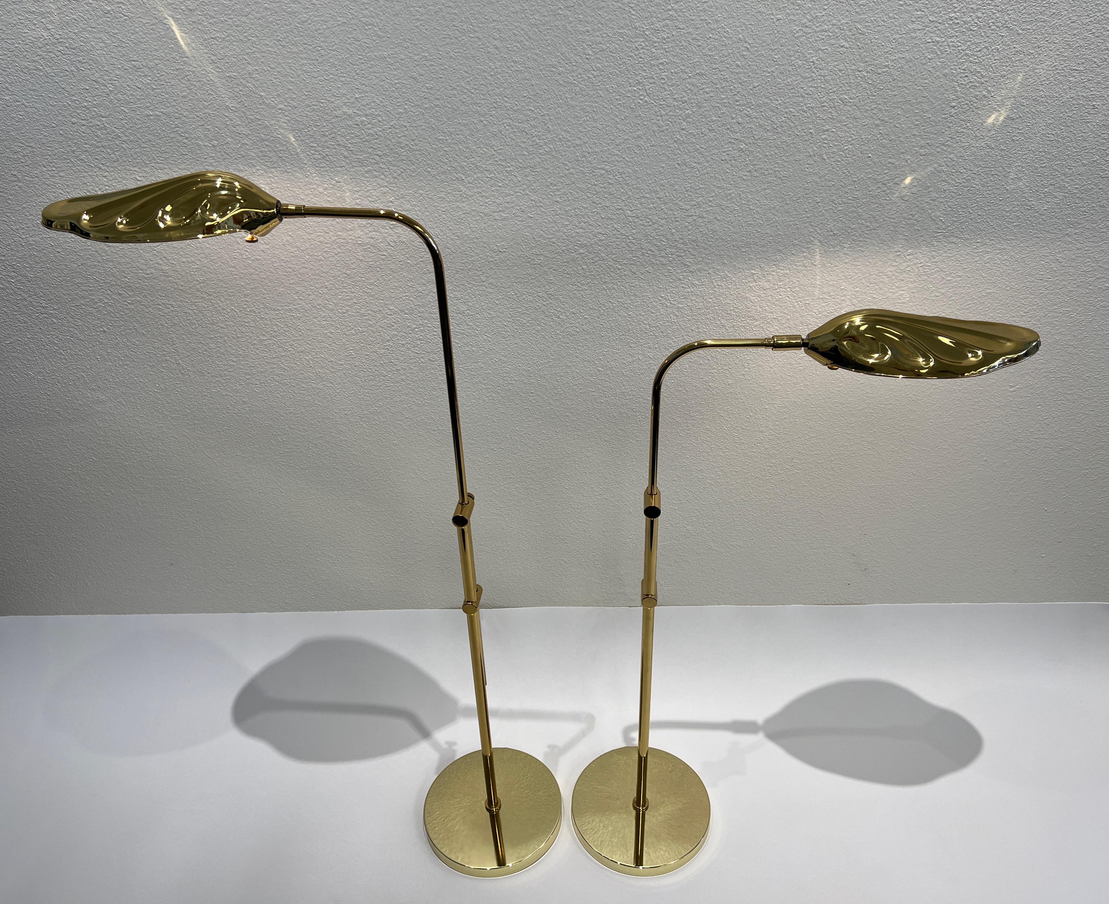 Pair of 1970’s polish brass leaf floor lamps attributed to Chapman. 
Newly rewired, can be adjusted up and down and rotated 360. 
75w max Edison lightbulb recommended. 
They show minor wear consistent with age. 

Measurements: 
24” wide, 10”