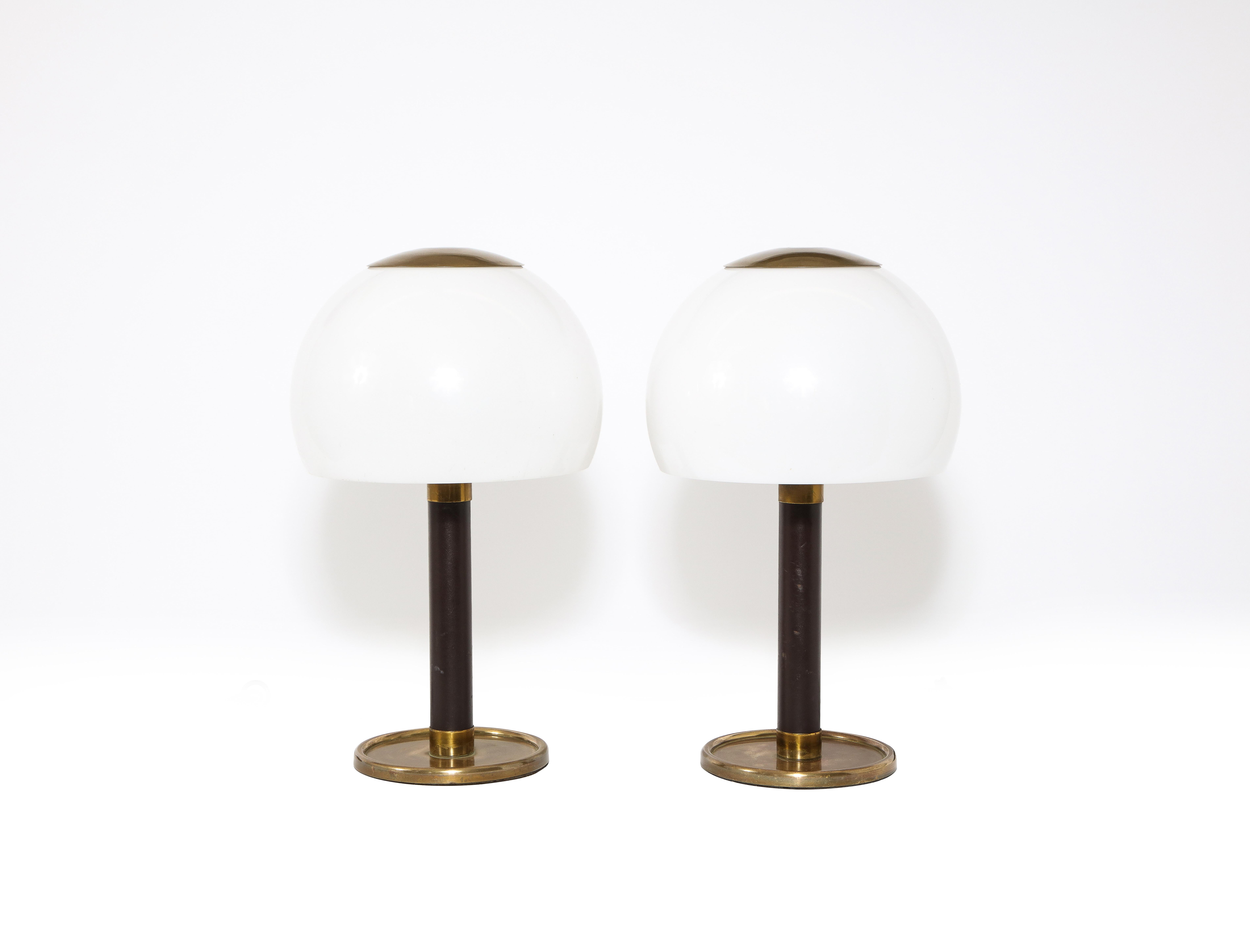 Elegant pair of leather and brass table lamps by MetalArte of Spain with original leather and a wonderful rich patina, the shades, made of perspex, are pristine. Rewired for the US.