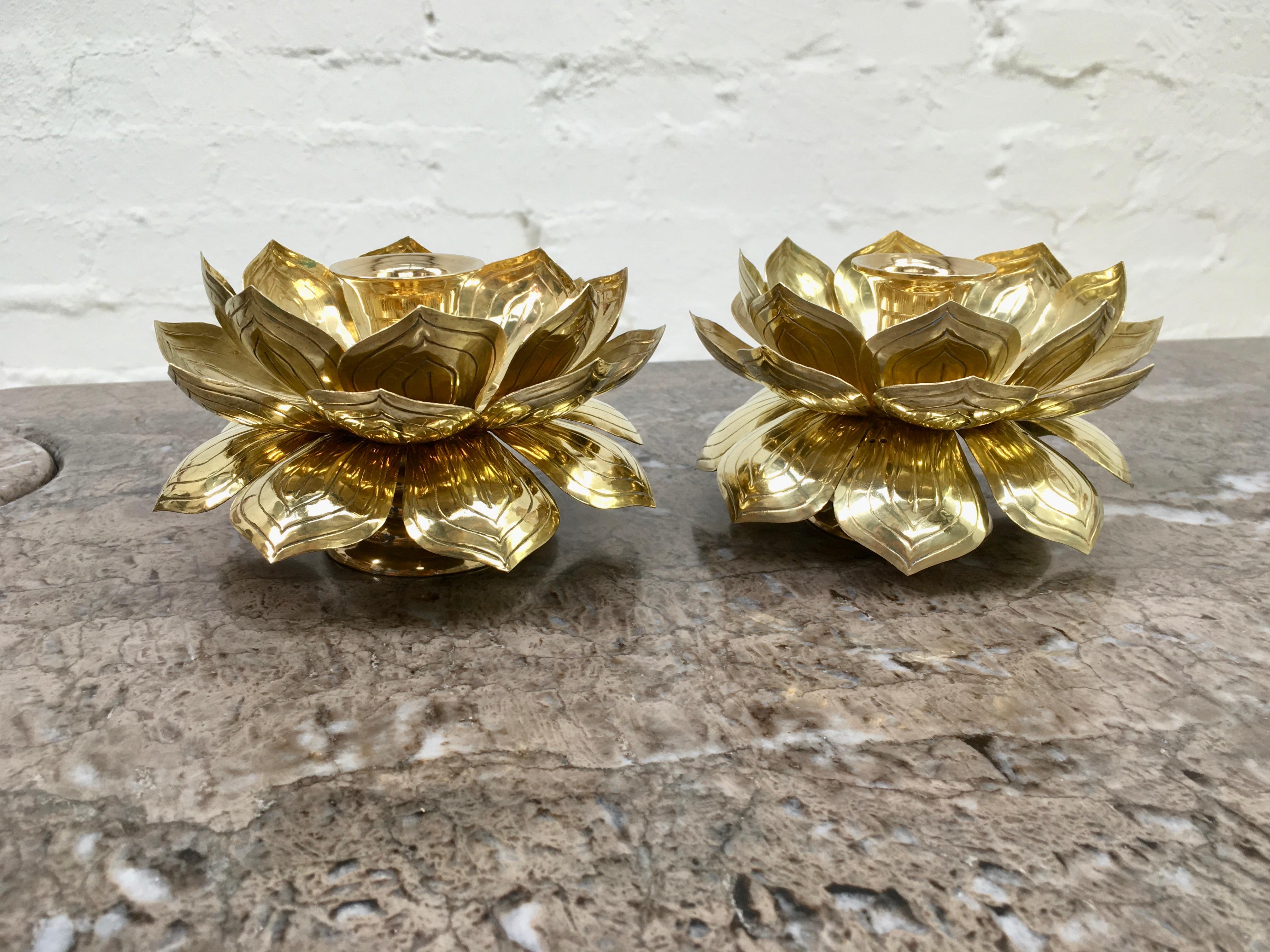 A pair of candleholders by Feldman. These are the smaller of the sizes, but not tiny, at 5.5 inches diameter and just over 3 inches high. 

One in excellent condition, the other with some mysterious, tiny, regular holes in the petals but