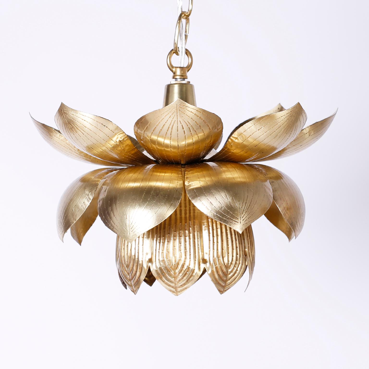 Chic pair of midcentury lotus pendants or light fixtures with an exotic ambiance, crafted in brass and hand polished and lacquered for easy care. Probably Feldman with a larger one also available. Priced Individually.