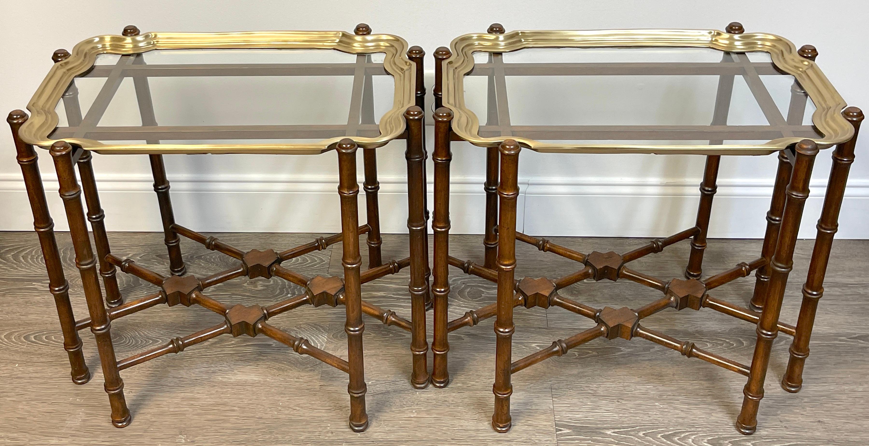 Pair of brass & mahogany Campaign style coffee tables or end tables.
Unmarked, Attributed to the Baker Furniture company 
Rare to find a pair, often used together as coffee tables, or can be used as end or side tables. 

Each one with a