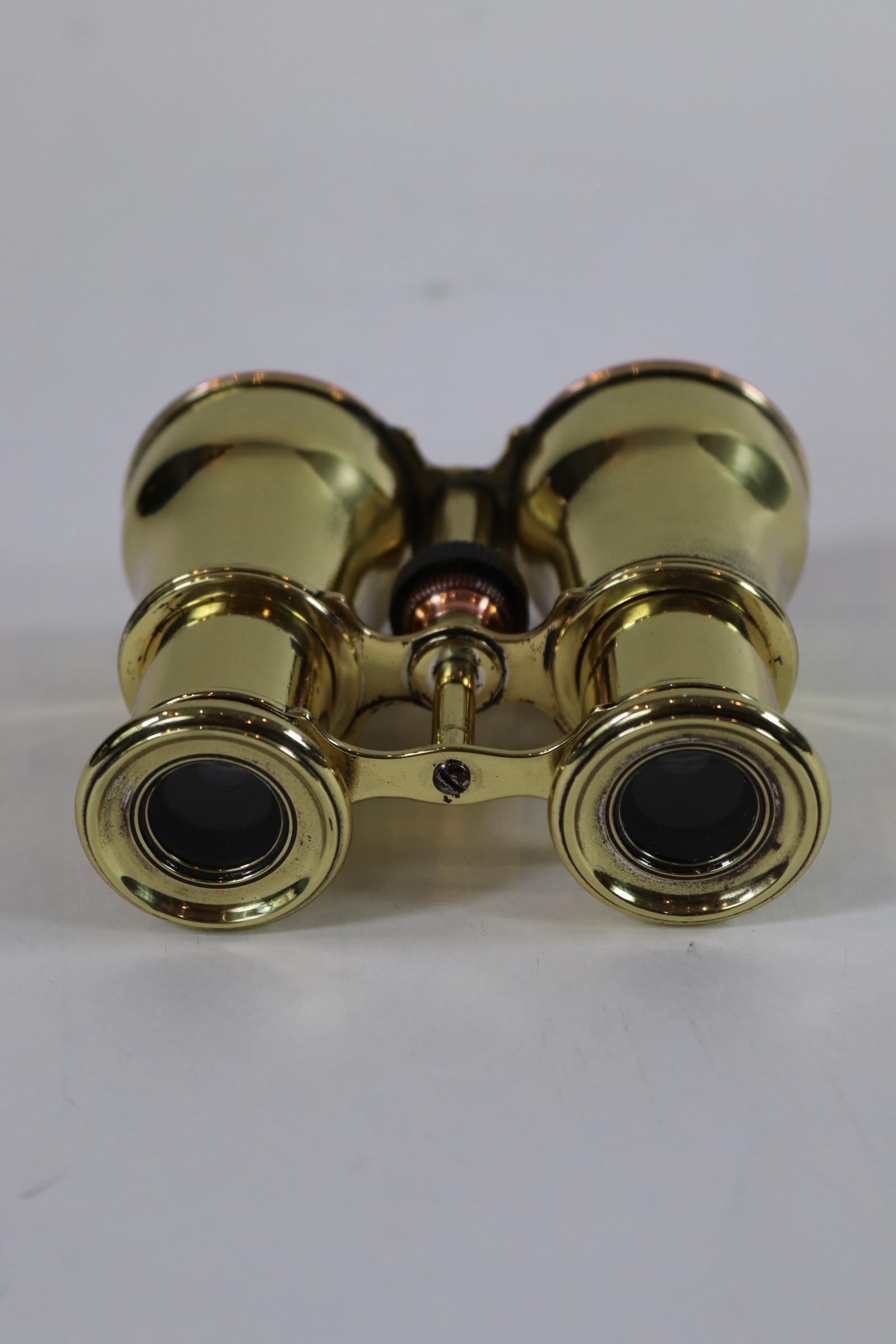 Pair of early 20th century marine binoculars. Polished and lacquered finish. Weight is 1 pound.