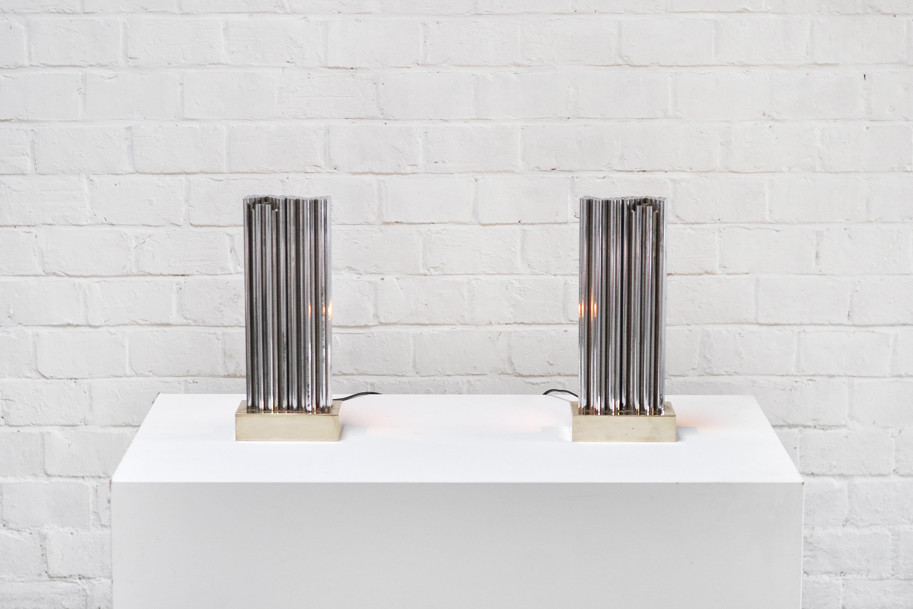 An important pair of sculpture lamps designed by Georges Mathias in the 1970s. These lamps feature a brass base with a metal geometric tube formation on top. 
Both lamps are signed on the back. Beautiful light emission thanks to the sculptural