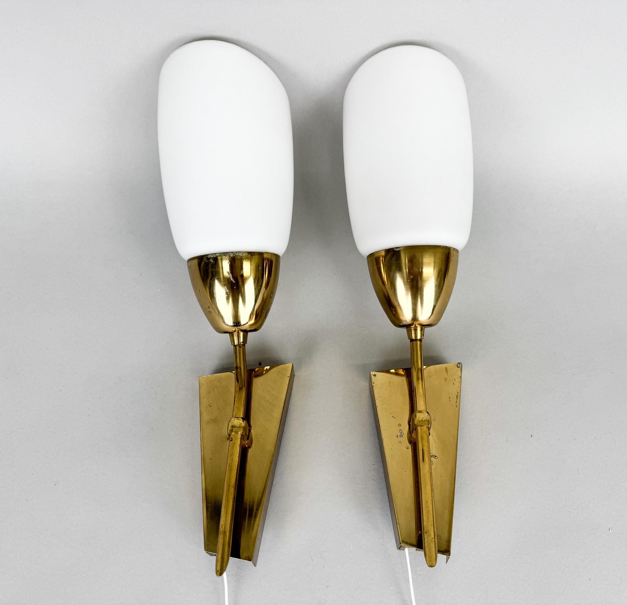 Set of two brass wall lamps with original milk glass shades. Made in the former Czechoslovakia by the famous Kamenický Šenov company in the 1960s. Very good vintage condition with slight signs of use (see photo). 
Bulbs: 2 x E14. Compatible with US
