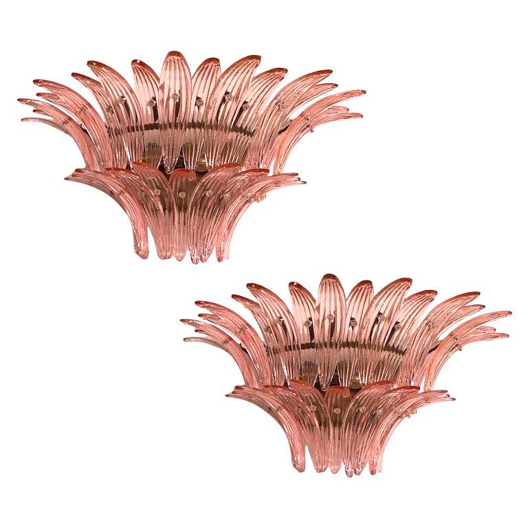 Each individual sconce is composed by 29 large pink leaves in pure Murano glass. Available four pairs of sconces and two pairs of chandeliers on two or three or four  levels.