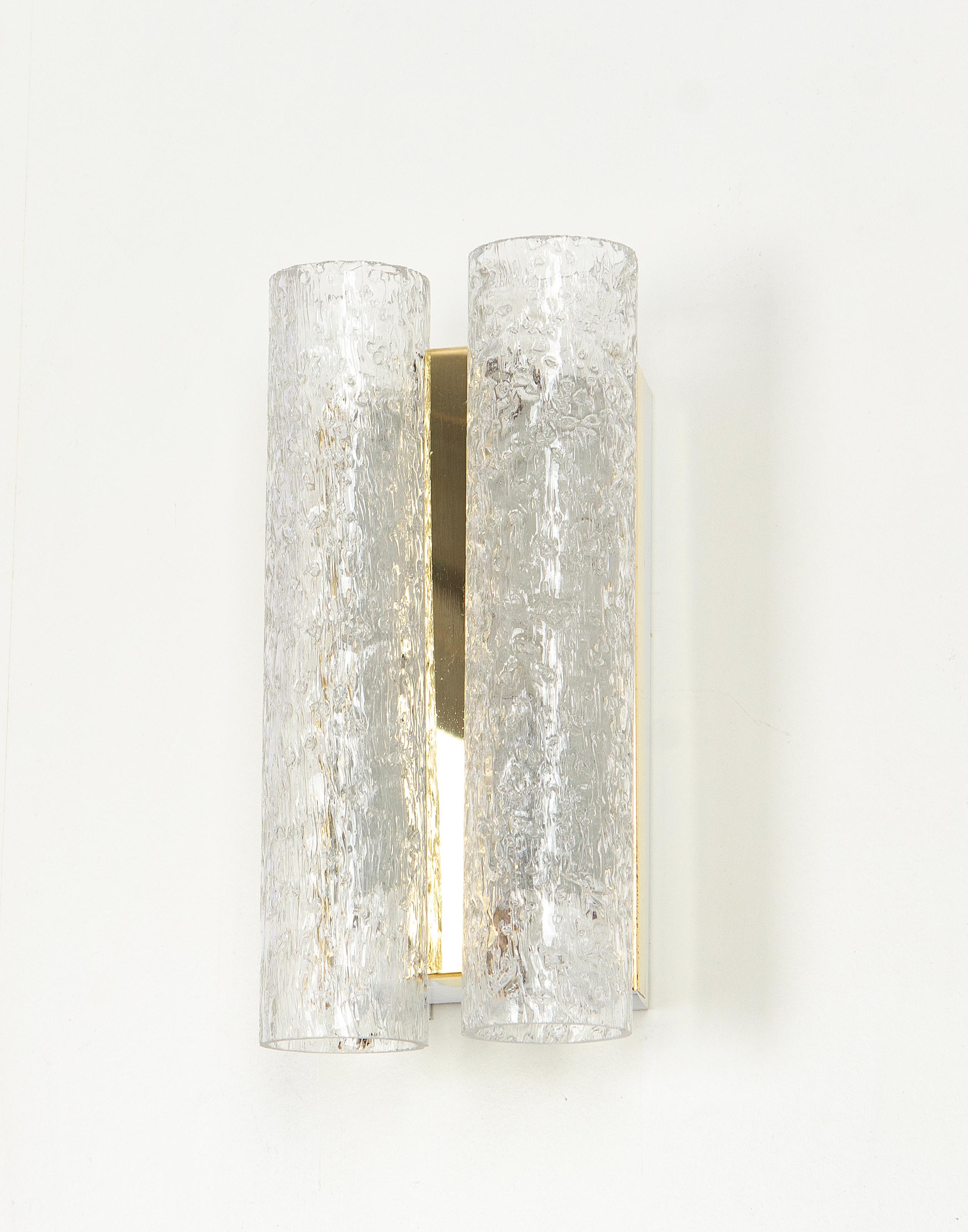 Wonderful pair of midcentury wall sconces with ice glass tubes, made by Doria Leuchten, Germany, manufactured, circa 1960-1969.

High quality and in very good condition. Cleaned, well-wired and ready to use. 

Each sconce requires 1 x E14 Small