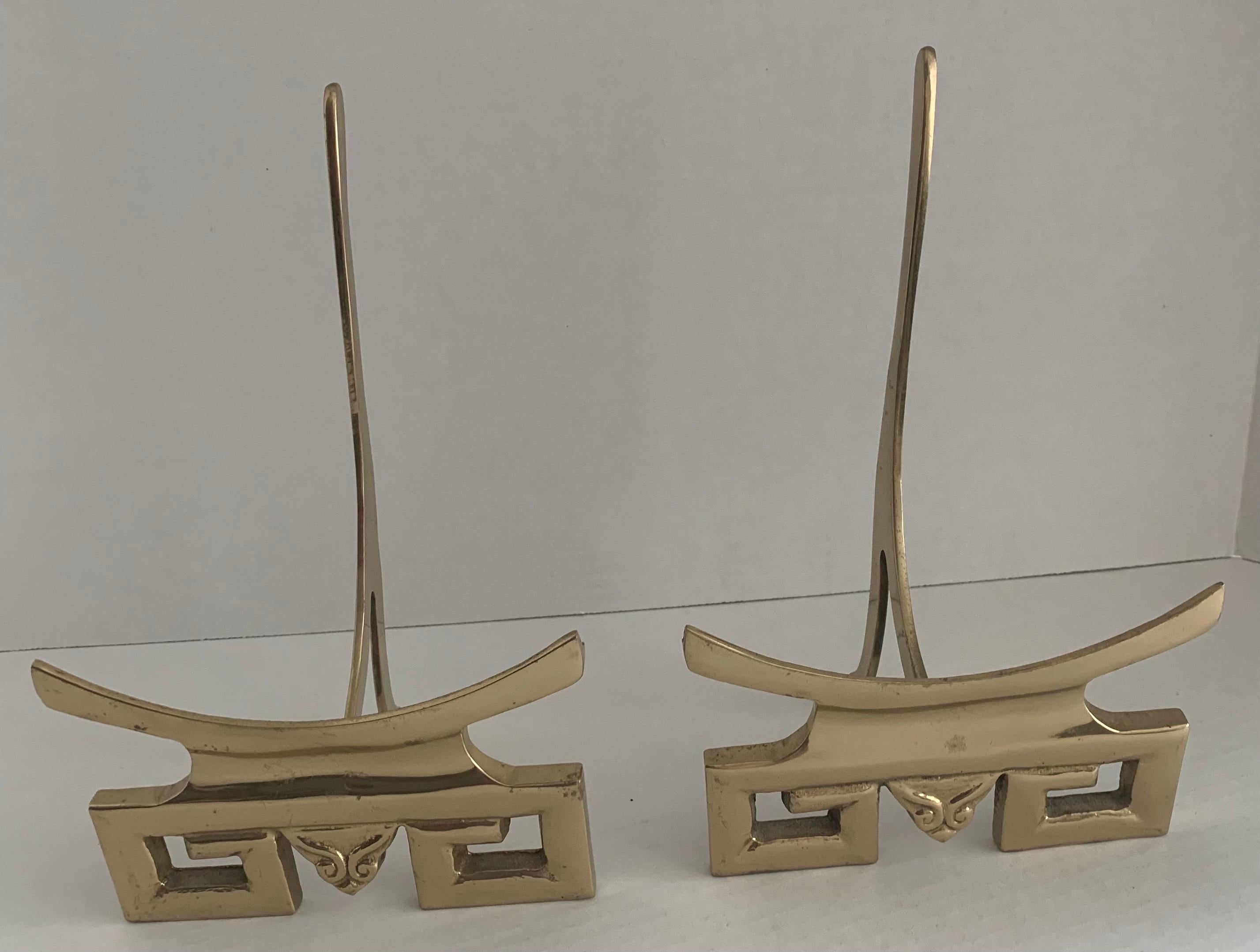 Pair of 1970s polished brass pagoda motif plate stands. Stands fold flat for storage. 
Last three photos show the stands with a 10” plate. 
