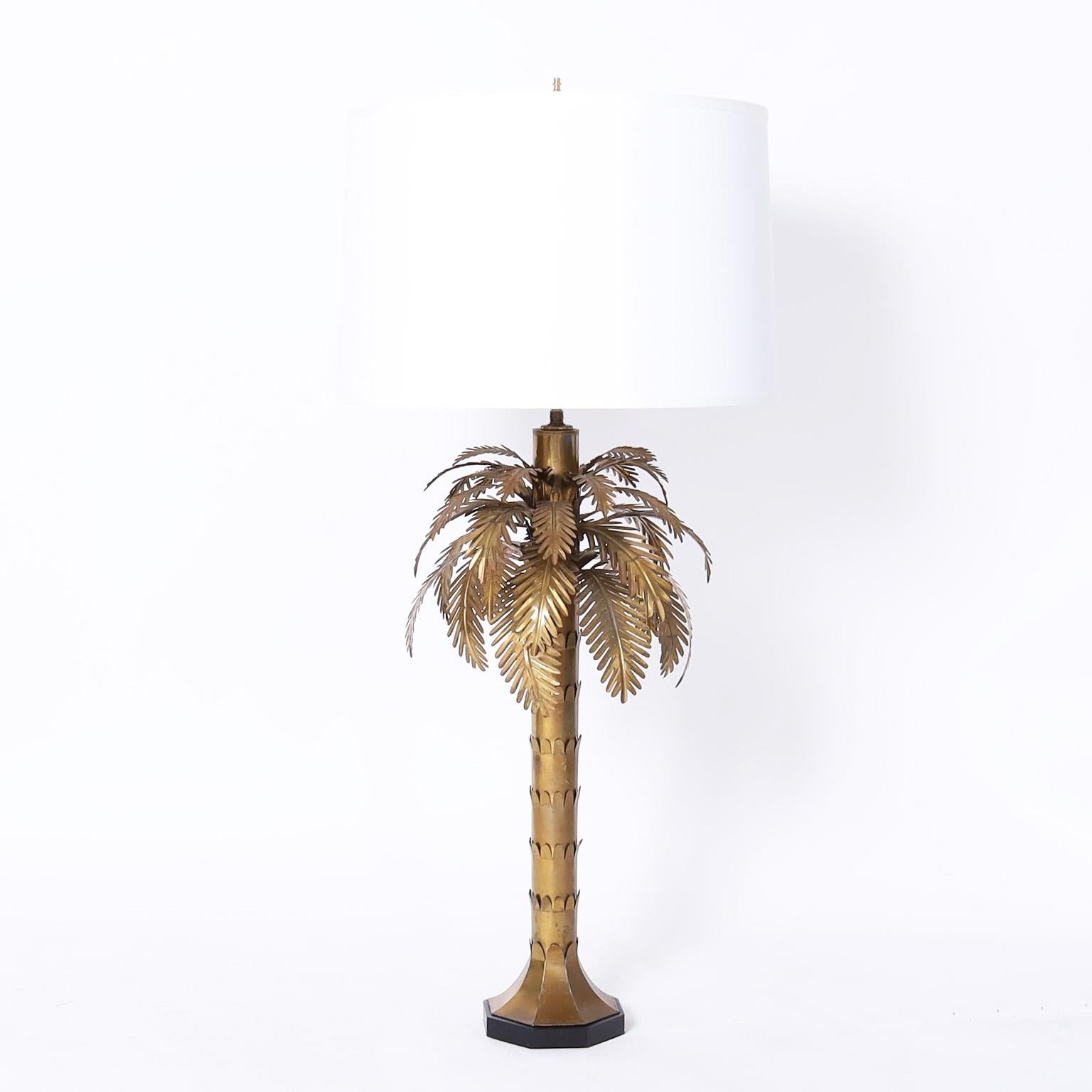 Chic mid century modern pair of table lamps crafted in brass in a stylized palm tree form on an octagon ebonized wood base. Best of the genre. 