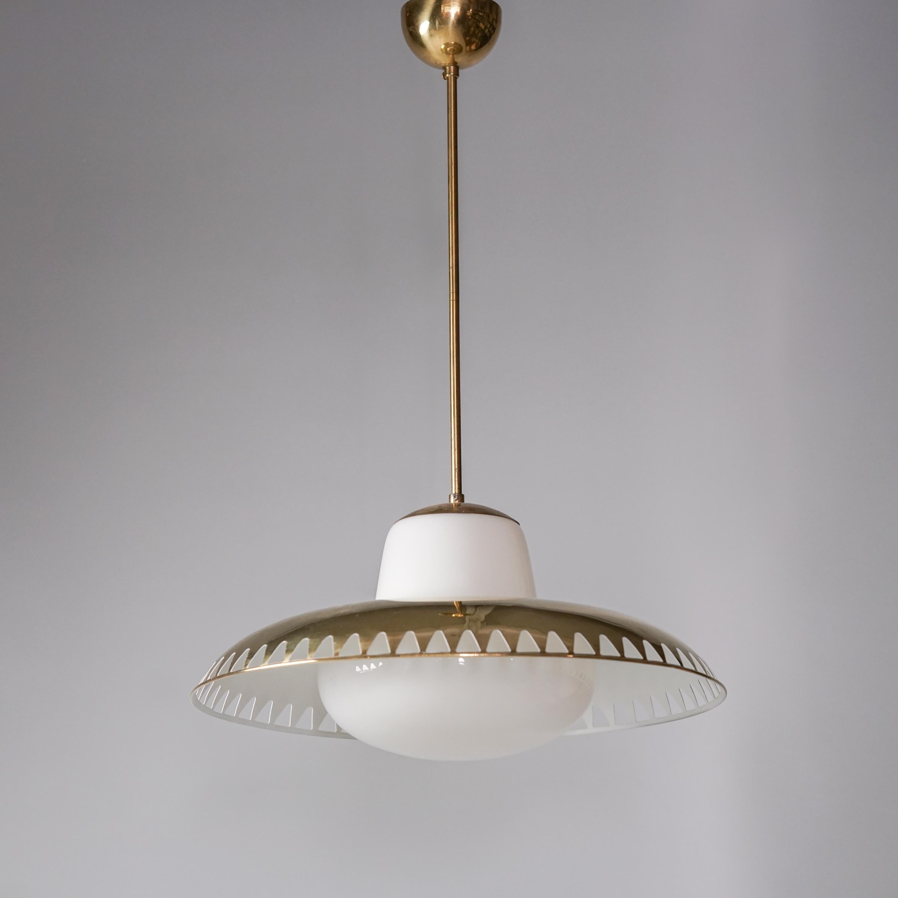 Pair of brass pendants by Lisa Johansson-Pape & Gunilla Jung, manufactured by Orno Oy, 1950s. Jung has designed the milk glass part and Johansson-Pape the brass shade. Good vintage condition, minor patina and wear consistent with age and use. The