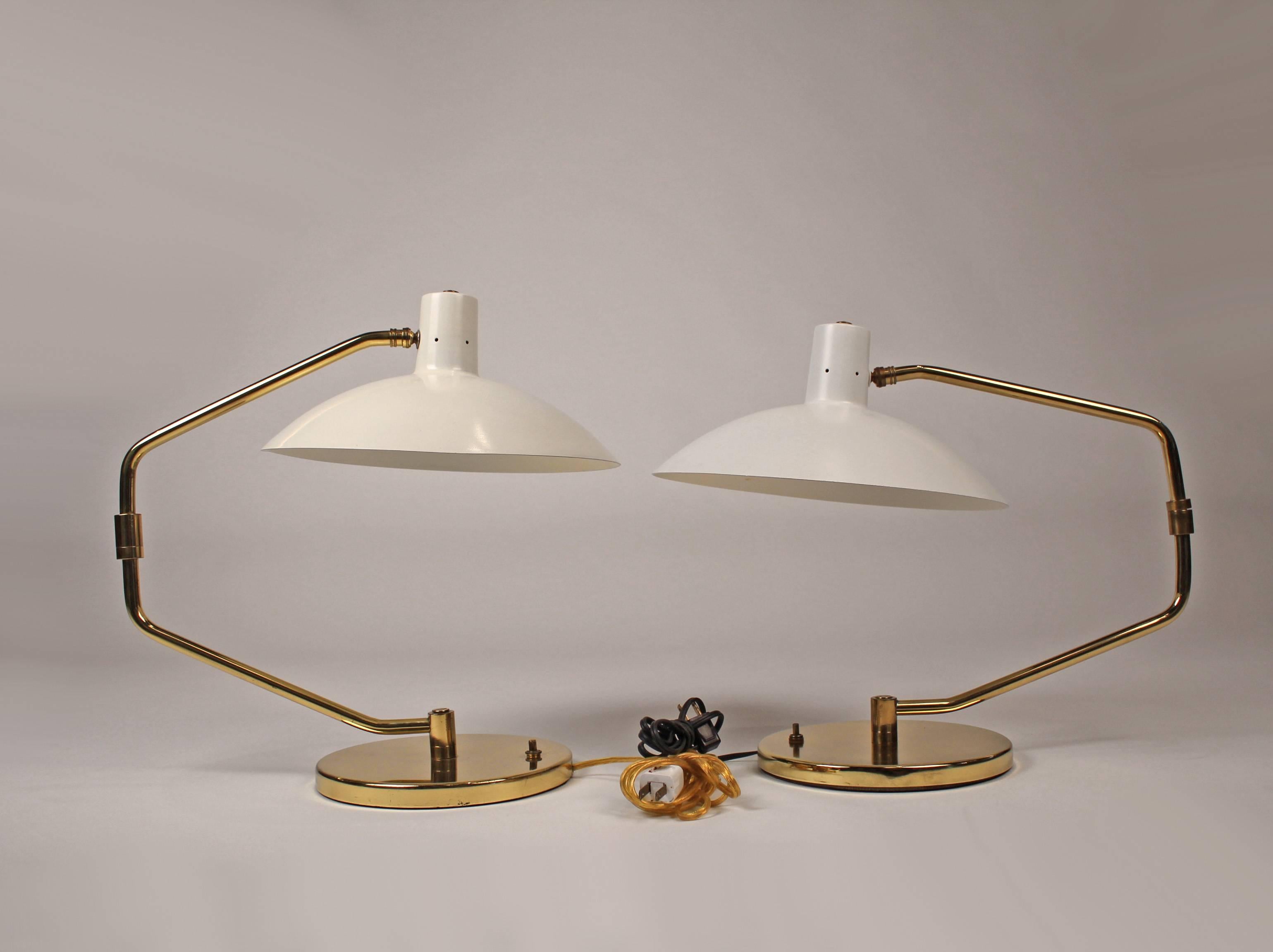 A pair of table lamps featuring adjustable shades with pivoting arms that extend to a length of 33 inches. One lamp is slightly older than the other so they are not a 100% match but indistinguishable when separated in a room. They would make amazing