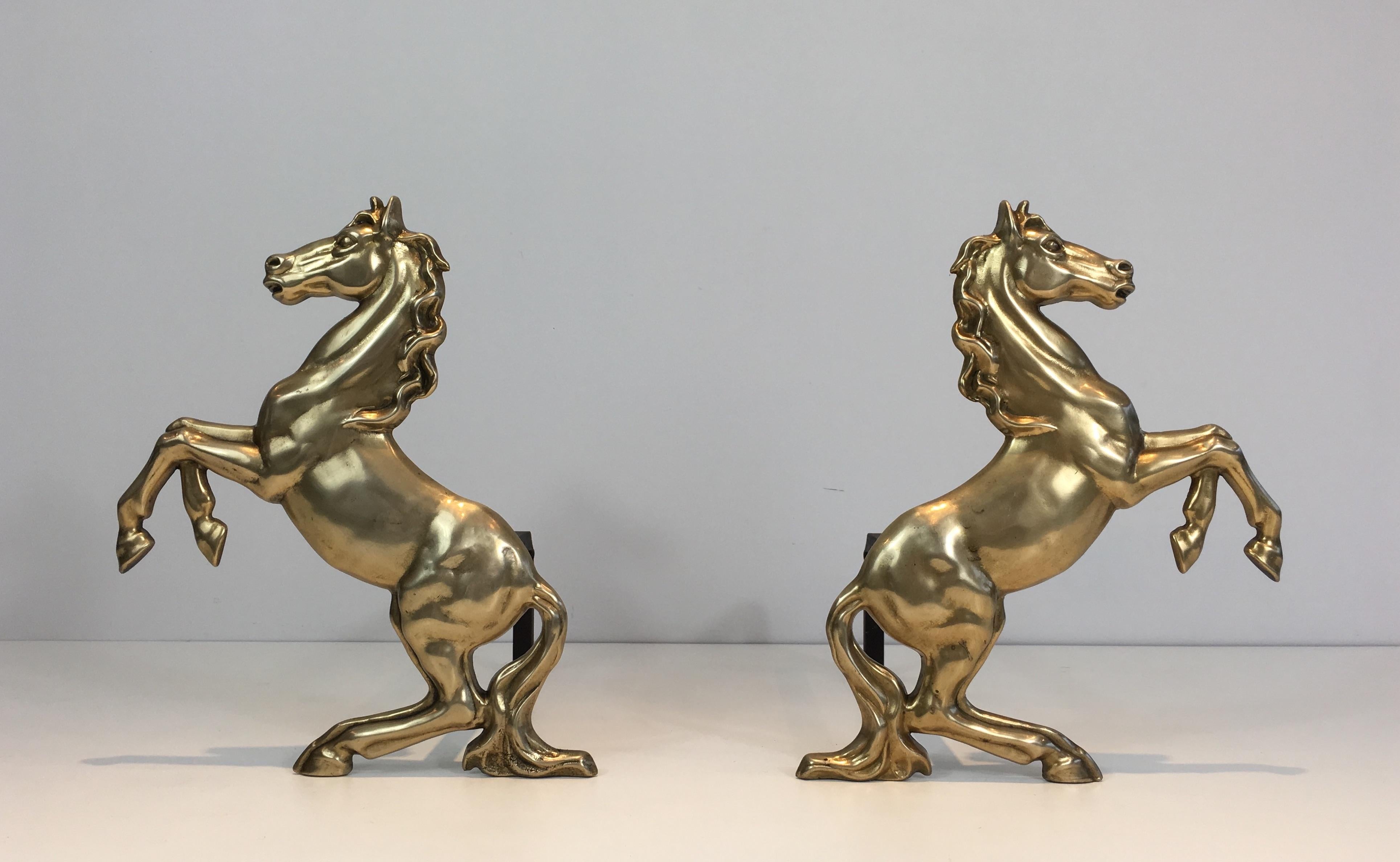 This pair of andirons is made of brass. They are showing prancing horses. This a French work, circa 1970.