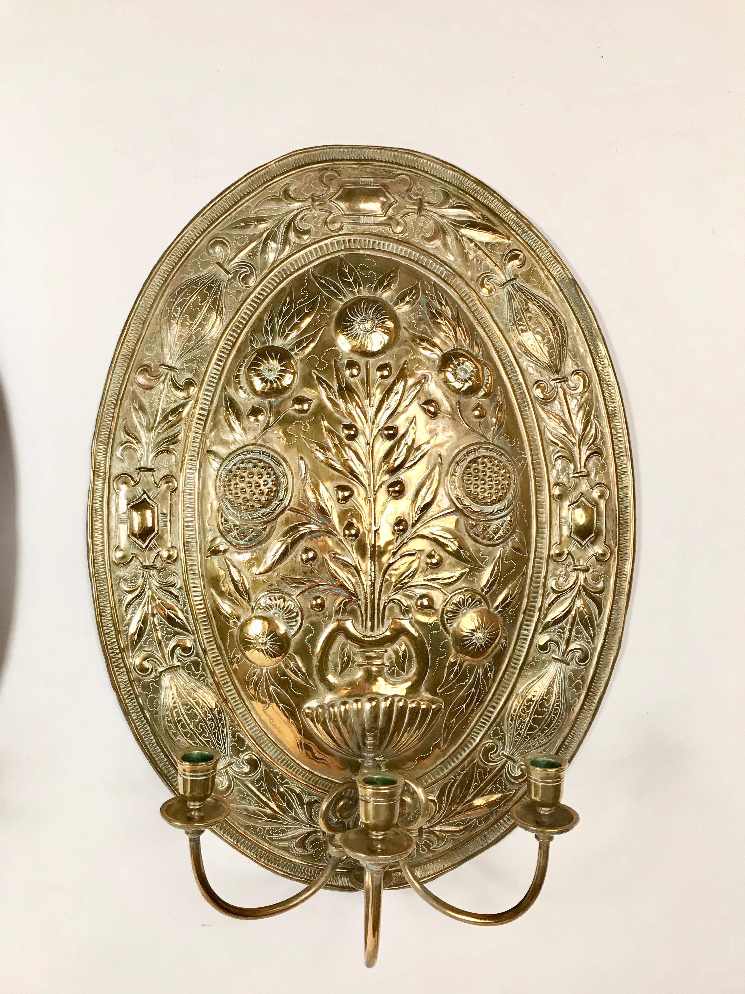 A high quality pair of Dutch Baroque style large scale wall sconces. The workmanship and detail on these is stunning, done by a master craftsman. Each oval back plate with a flower-filled urn issuing three scrolling candle arms.
A compliment to any
