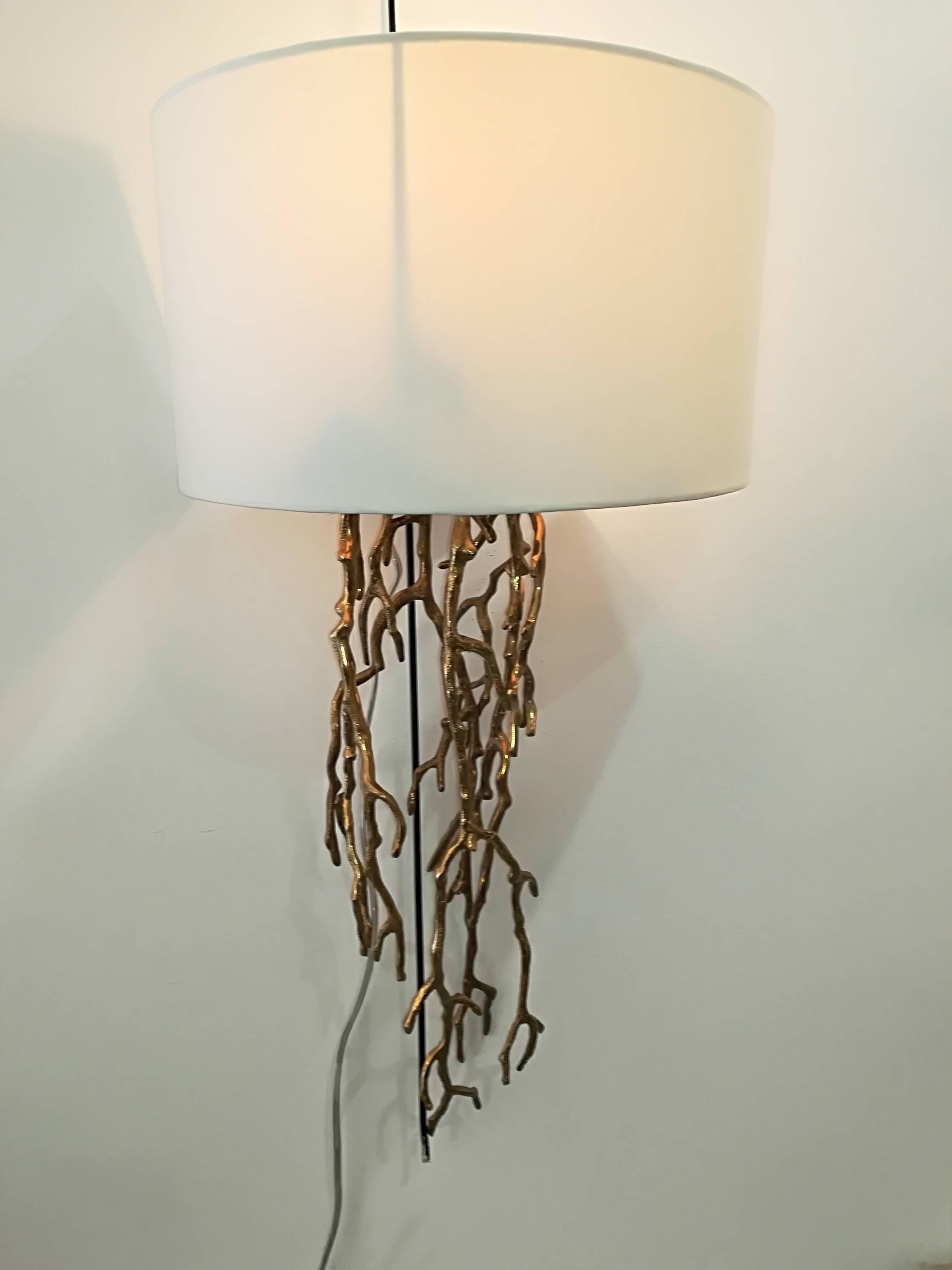 Pair of sconces, provided with elegant white lampshades.