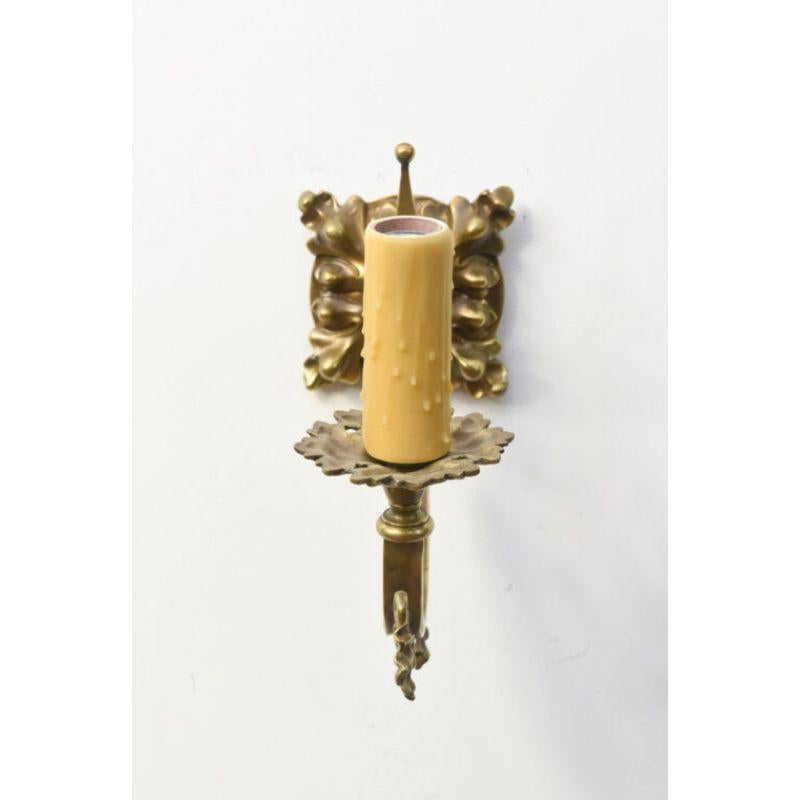 Heavy square foliate backplate.  Upwardly curved square arm, decorated with grape leaves and tendrils. Beautiful Casting, early electric sconces, possibly made by EF Caldwell,  from a building with marked EF Caldwell Lighting, but without markings. 