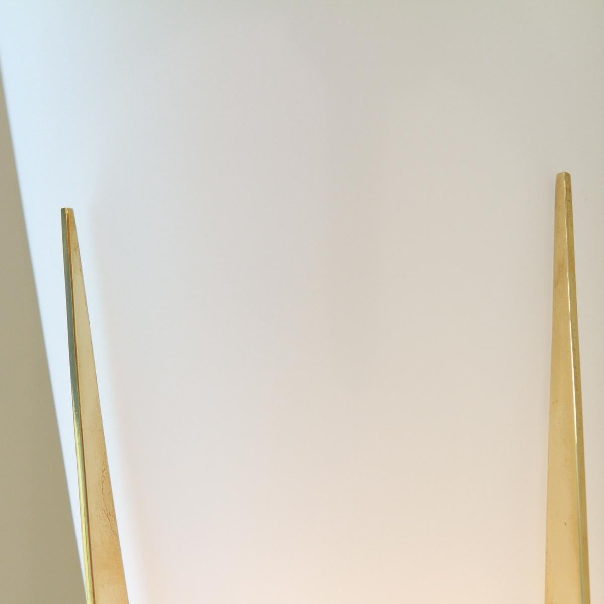 Pair of brass sconces with conical frosted glass shades.