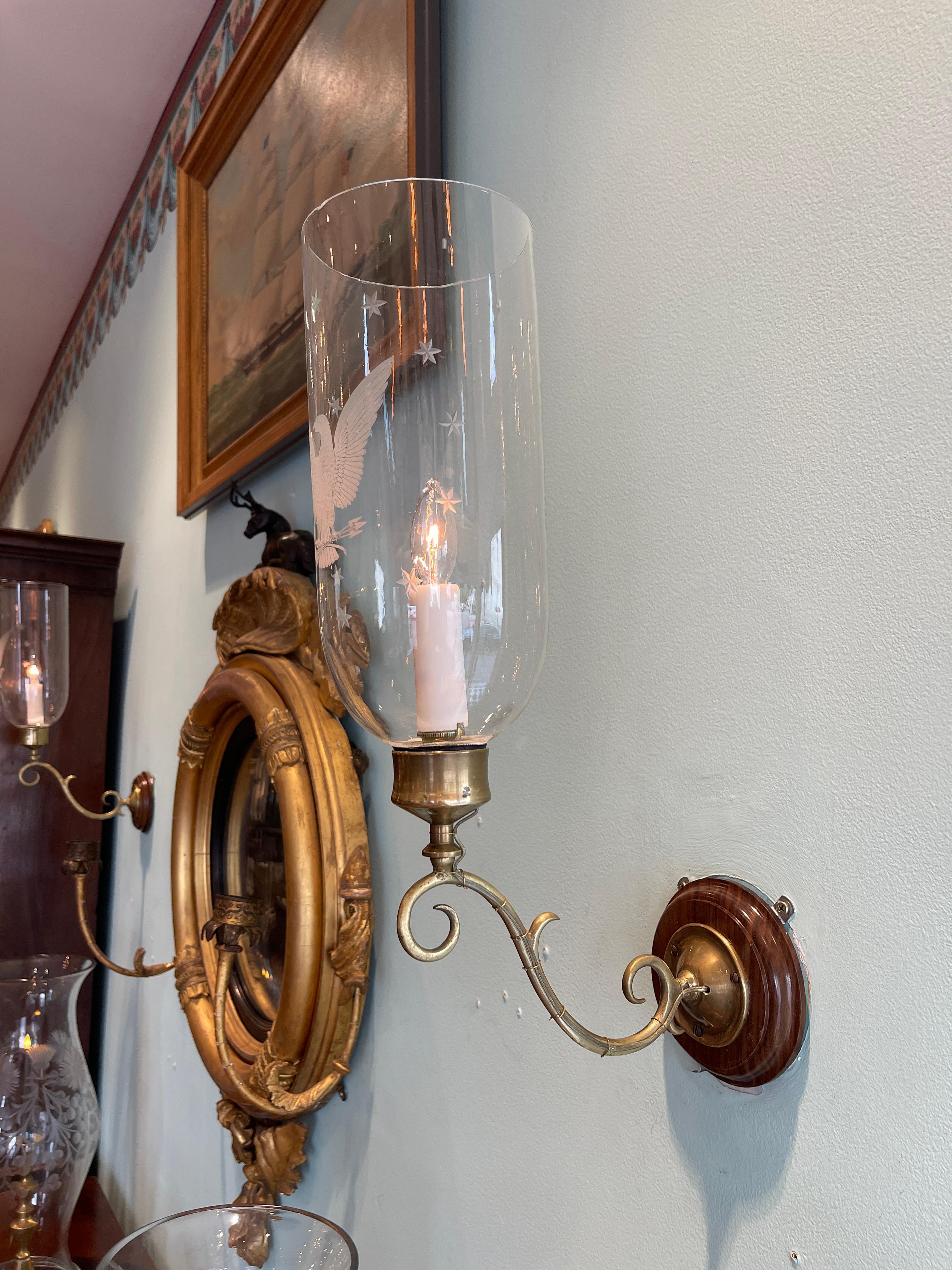 Pair of brass sconces with etched glass eagle motif shades In Good Condition For Sale In Charleston, SC
