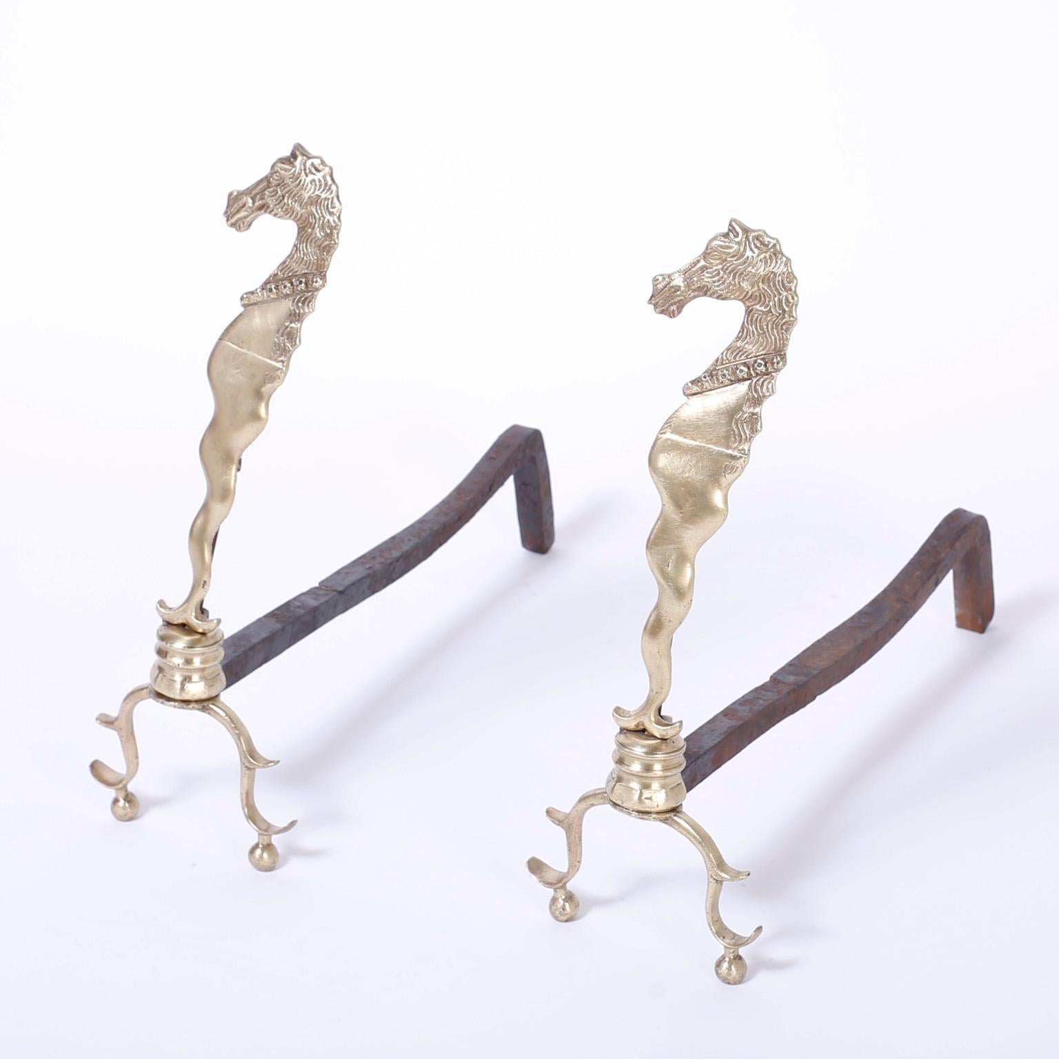 Pair of antique hand polished English brass andirons with sea horses as the main elements over a turned plinth on Queen Anne style cabriole legs and ball feet.