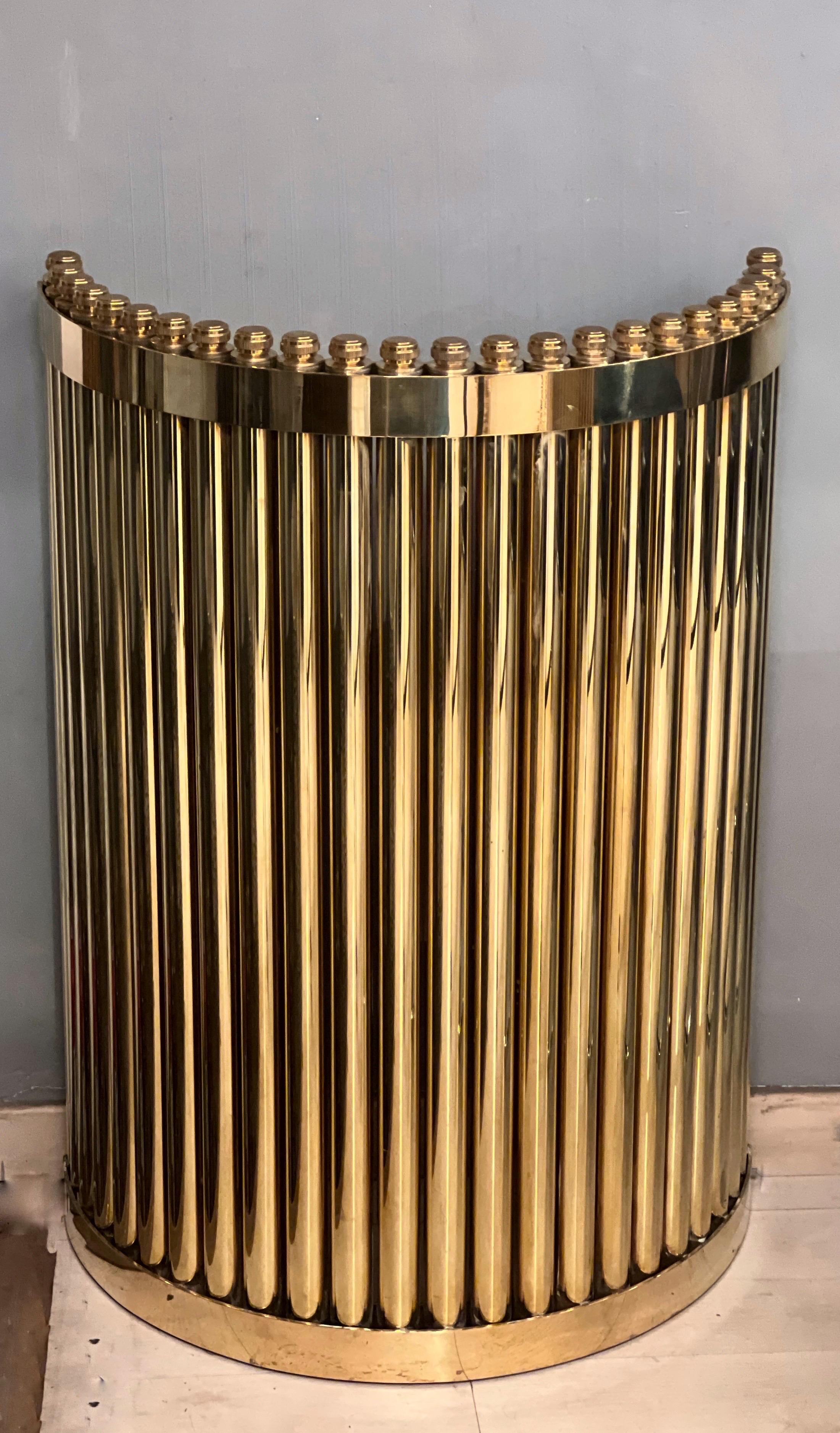 Pair of brass semicircular table bases or consoles. The basements are made of a multitude of brass tubes fixed in a single semicircular block. They are heavy and they have an industrial taste.
They can be used as basements for a dining table with a