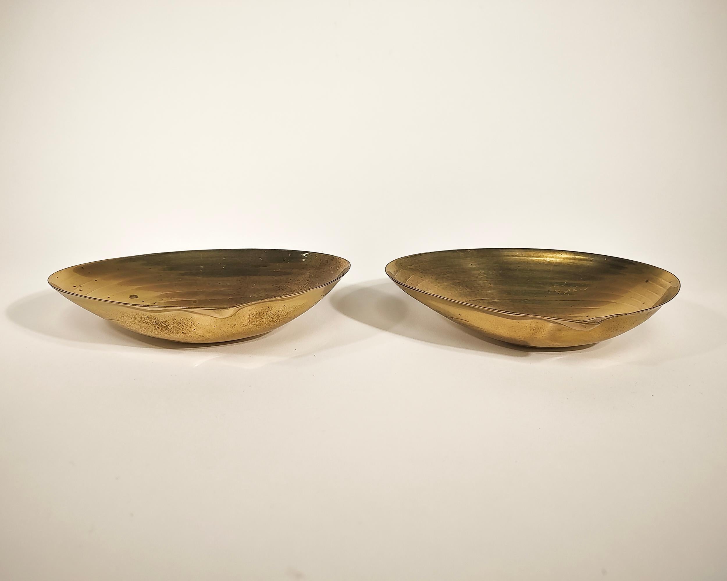 Pair of clam shell ashtrays or small catch dishes. Solid brass with small ball feet, stamped IFS Ltd on the back.