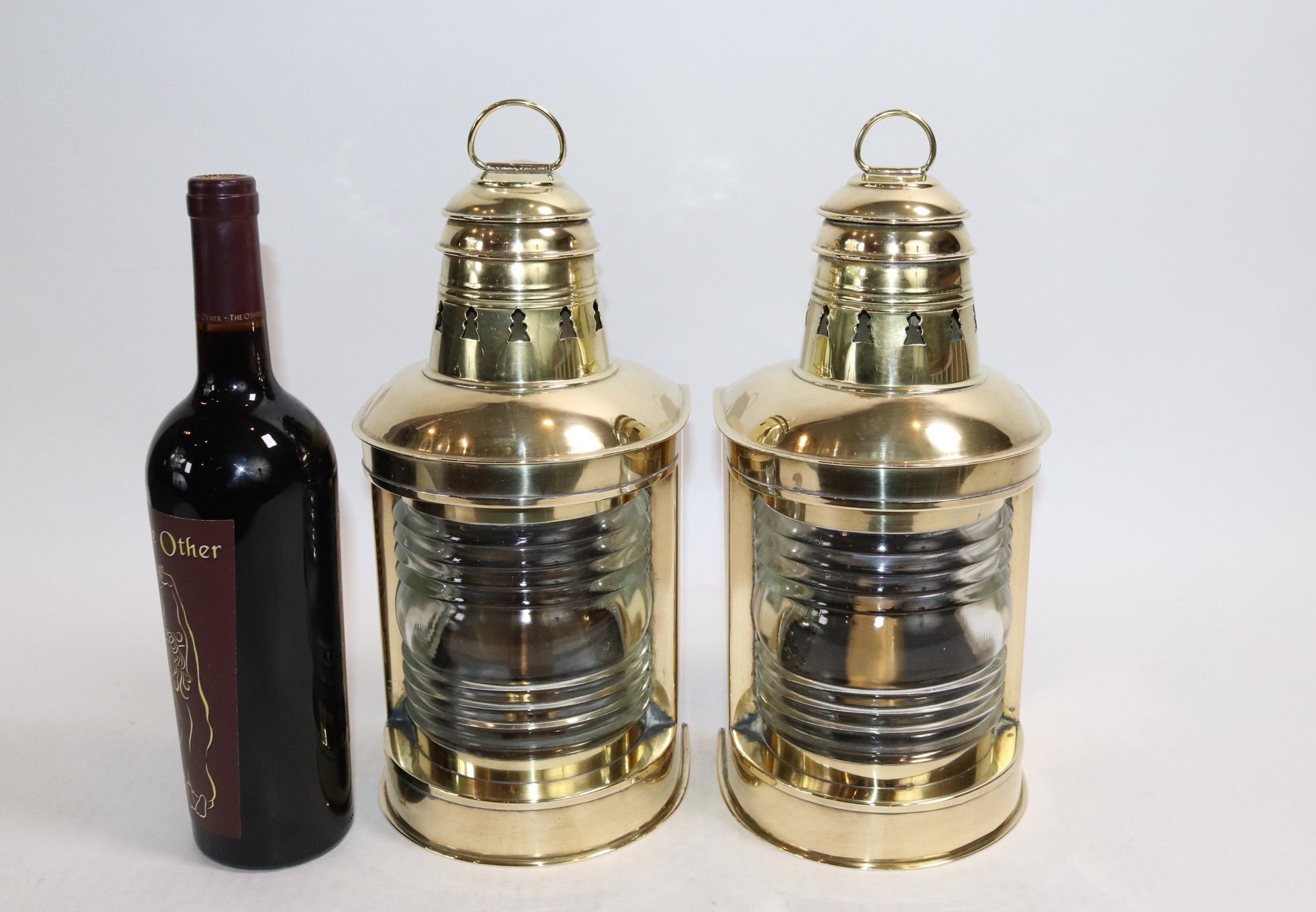 Pair of polished and lacquered Perko masthead ships lanterns with fresnel lenses, carry rings, vented tops, burners and mounting flanges. Weight is 8 pounds.