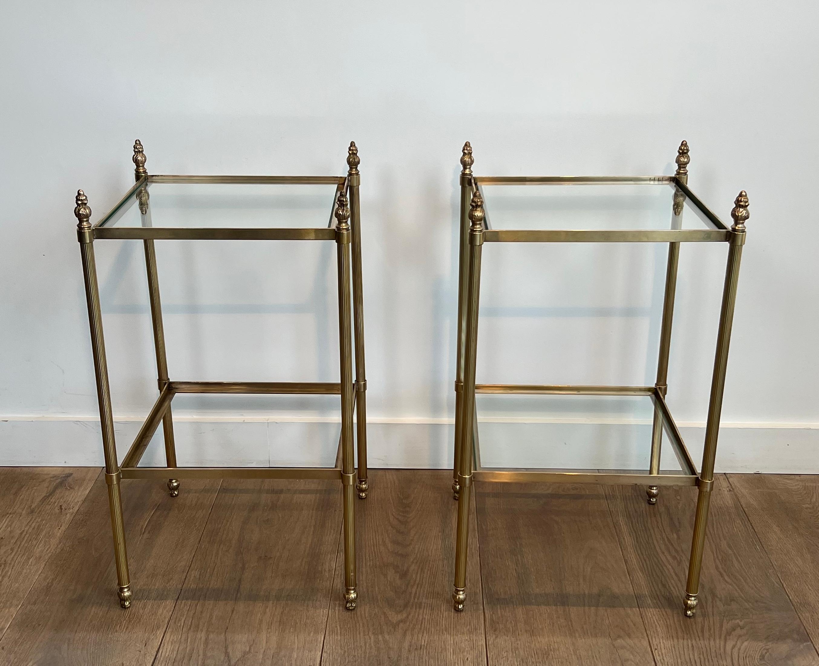 This very nice and elegant pair of side tables with 2 tiers are made of brass and fluted legs. This is a French work attributed to Maison Jansen. Circa 1940