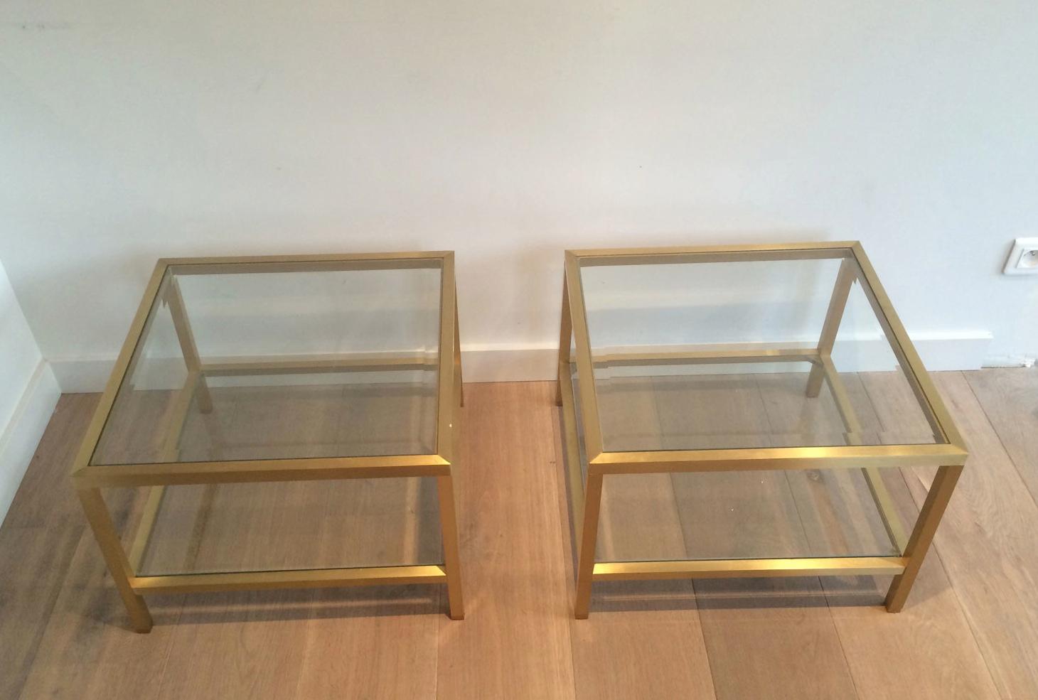 This pair of square side tables is made of brass with 2 glass shelves. This is a French work, circa 1960.