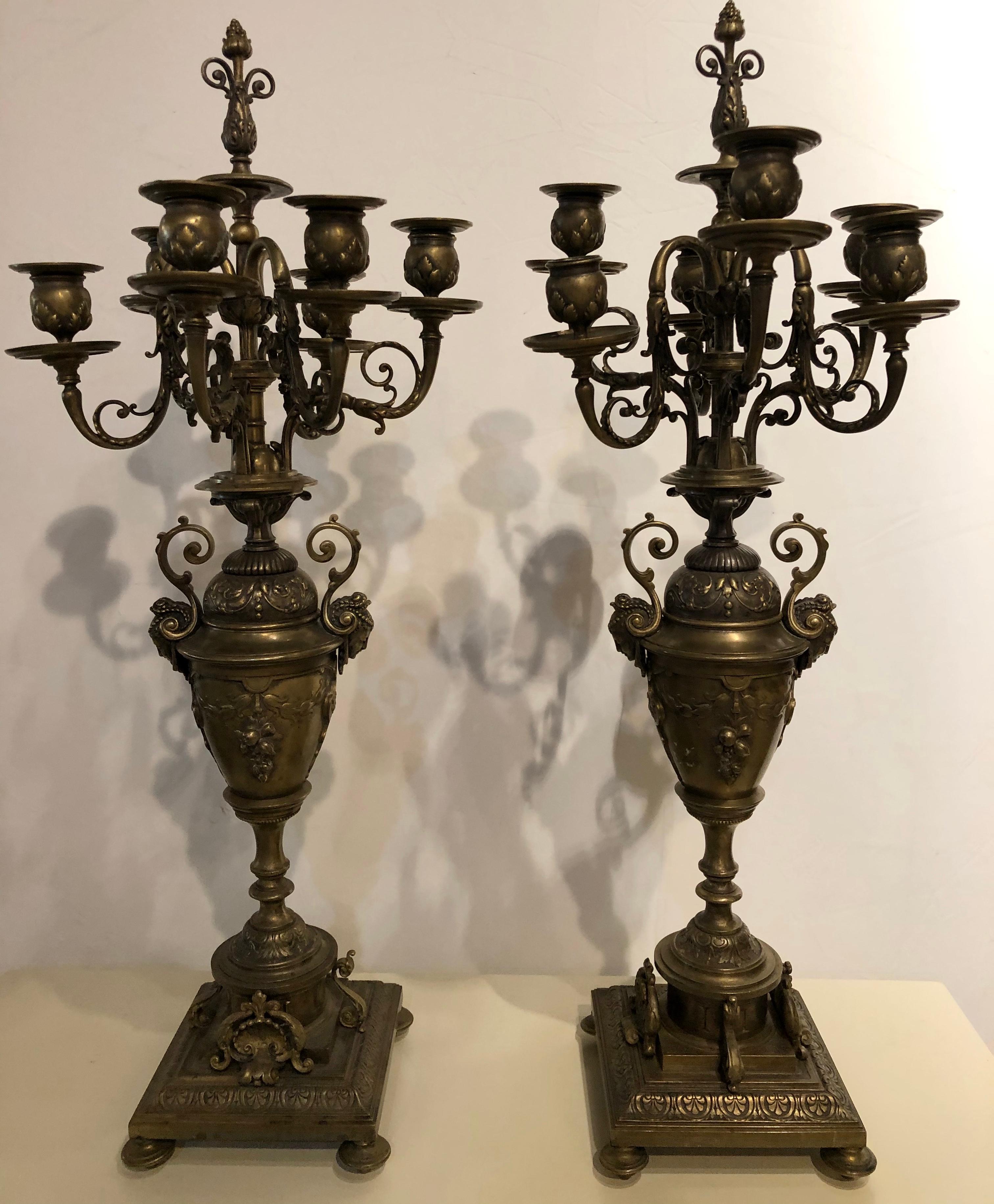 Pair of brass six-arm candelabras bearing figurative faces and fruits. These fine quality brass candelabras are much more impressive in real life than they could ever look in a picture. Each bearing a jeweled bust of a young woman. 


IXX.