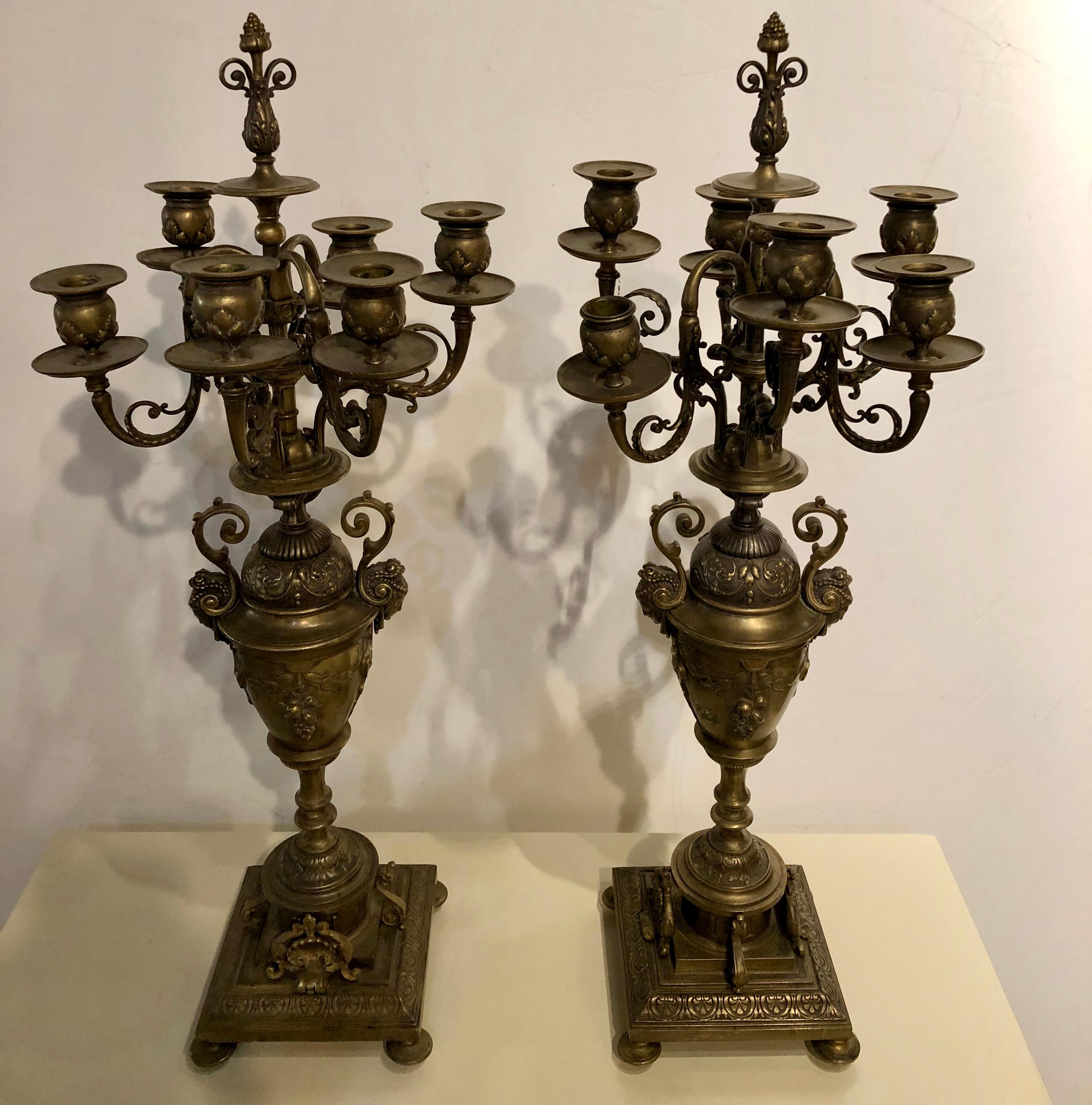 Neoclassical Pair of Brass Six-Arm Candelabras Bearing Figurative Faces and Fruits