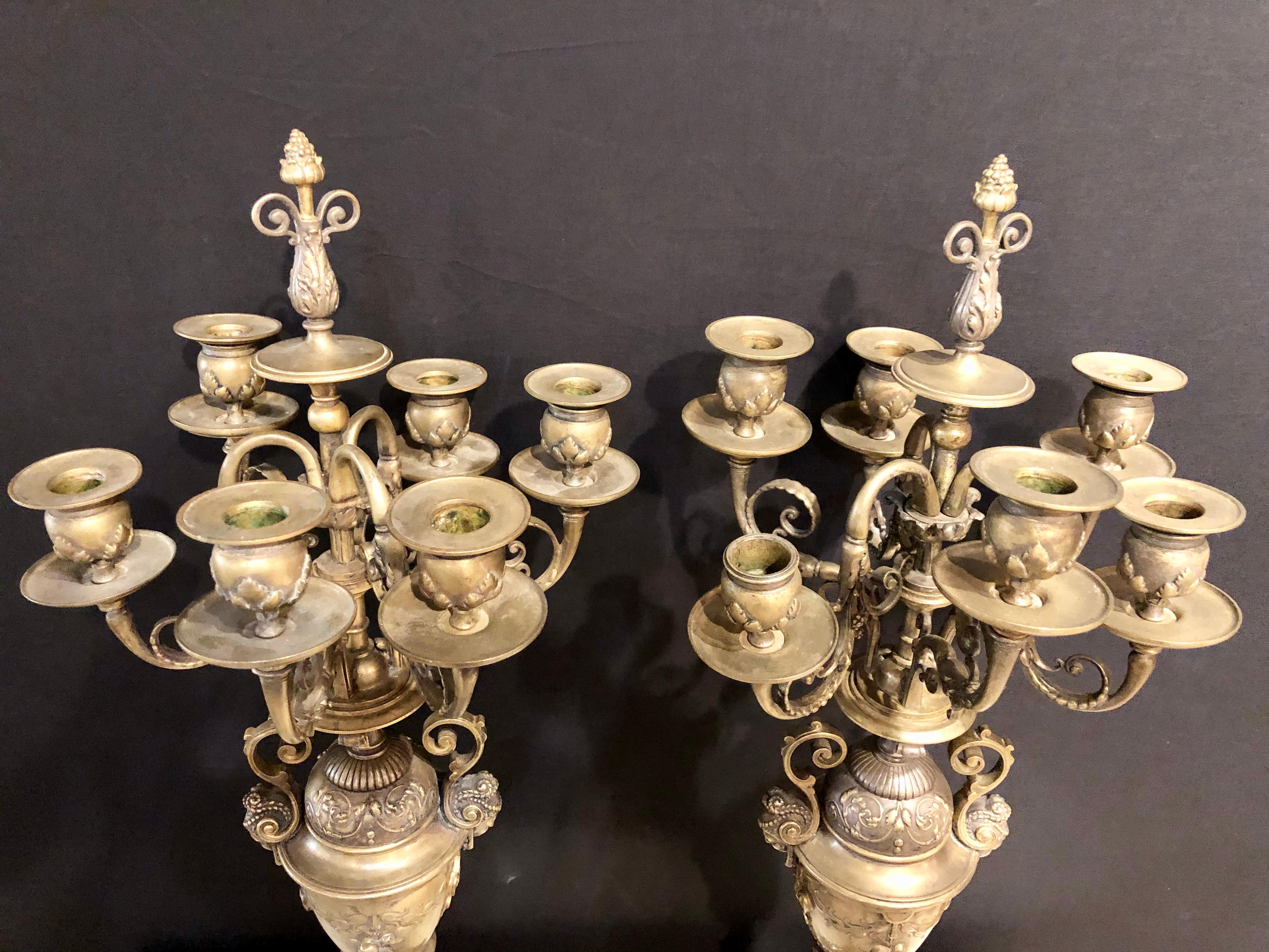 Bronze Pair of Brass Six-Arm Candelabras Bearing Figurative Faces and Fruits