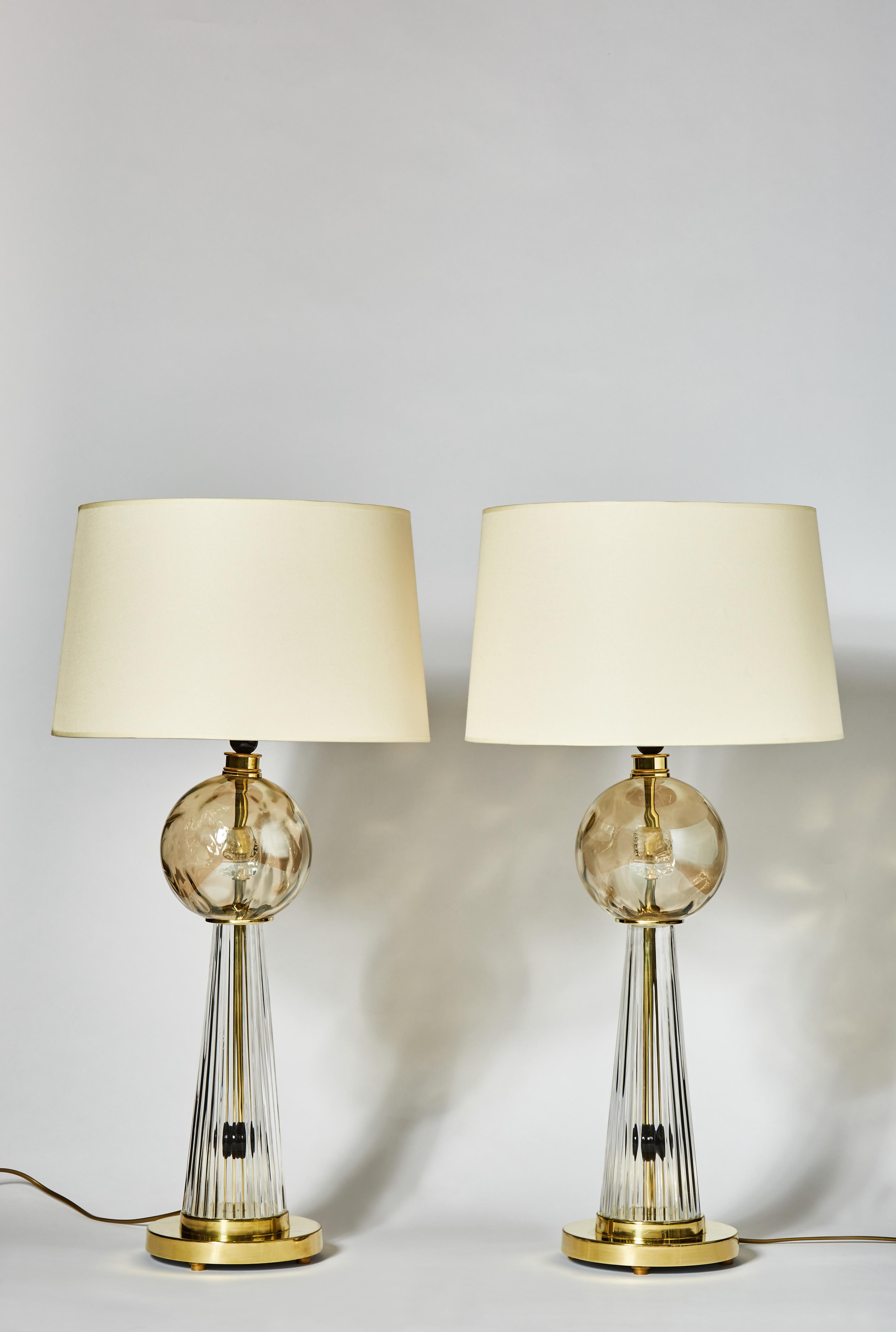 Pair of table lamps made of brass and Murano glass including a beautiful textured golden globe in the center.