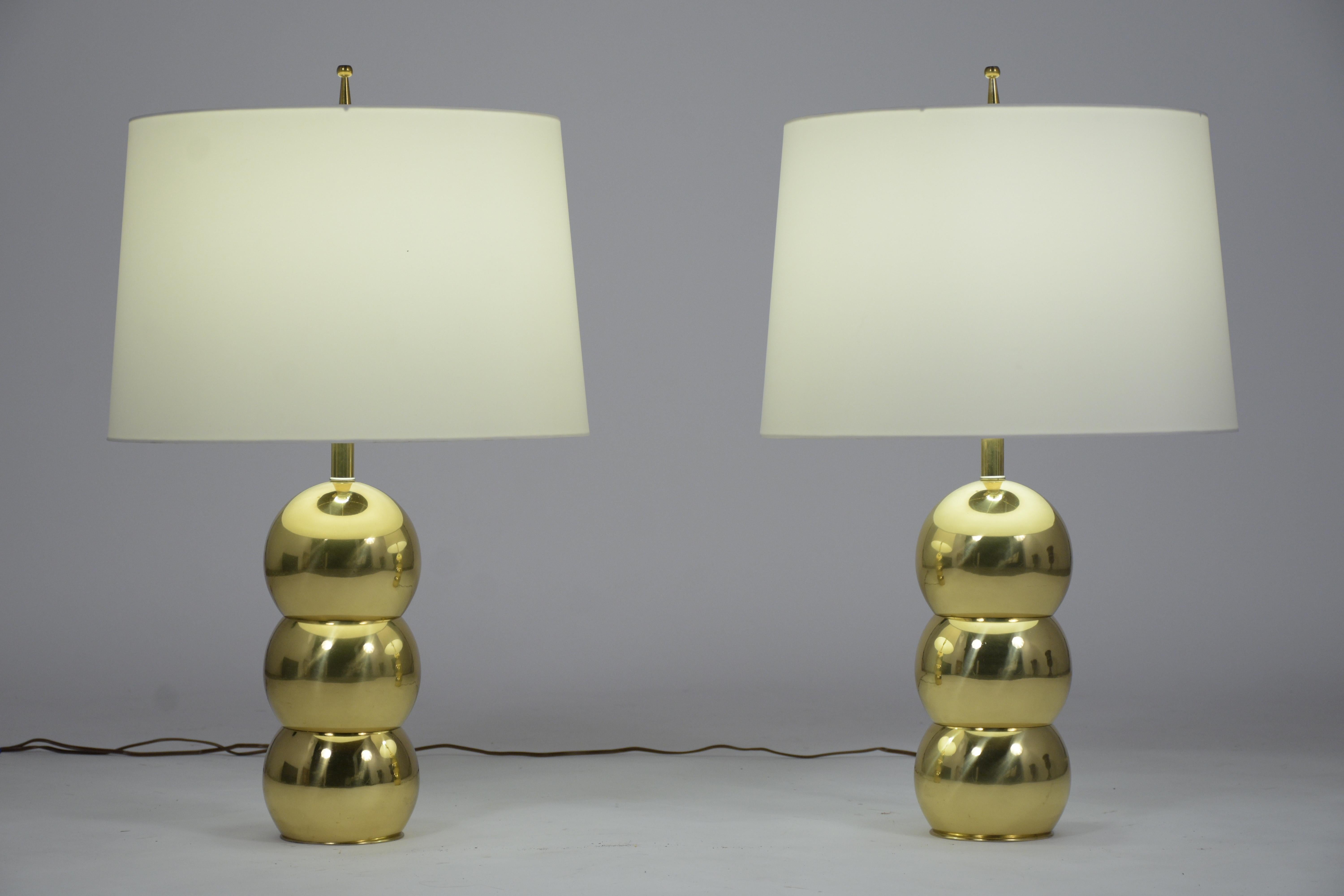 This pair of Fabulous 1960s Table Lamps are eye-catching with unique spherical brass bases and come with new white fabric lampshades. The lamp is wired to US standards and is in working condition. This pair of Vintage Mid Century Lamps are stunning