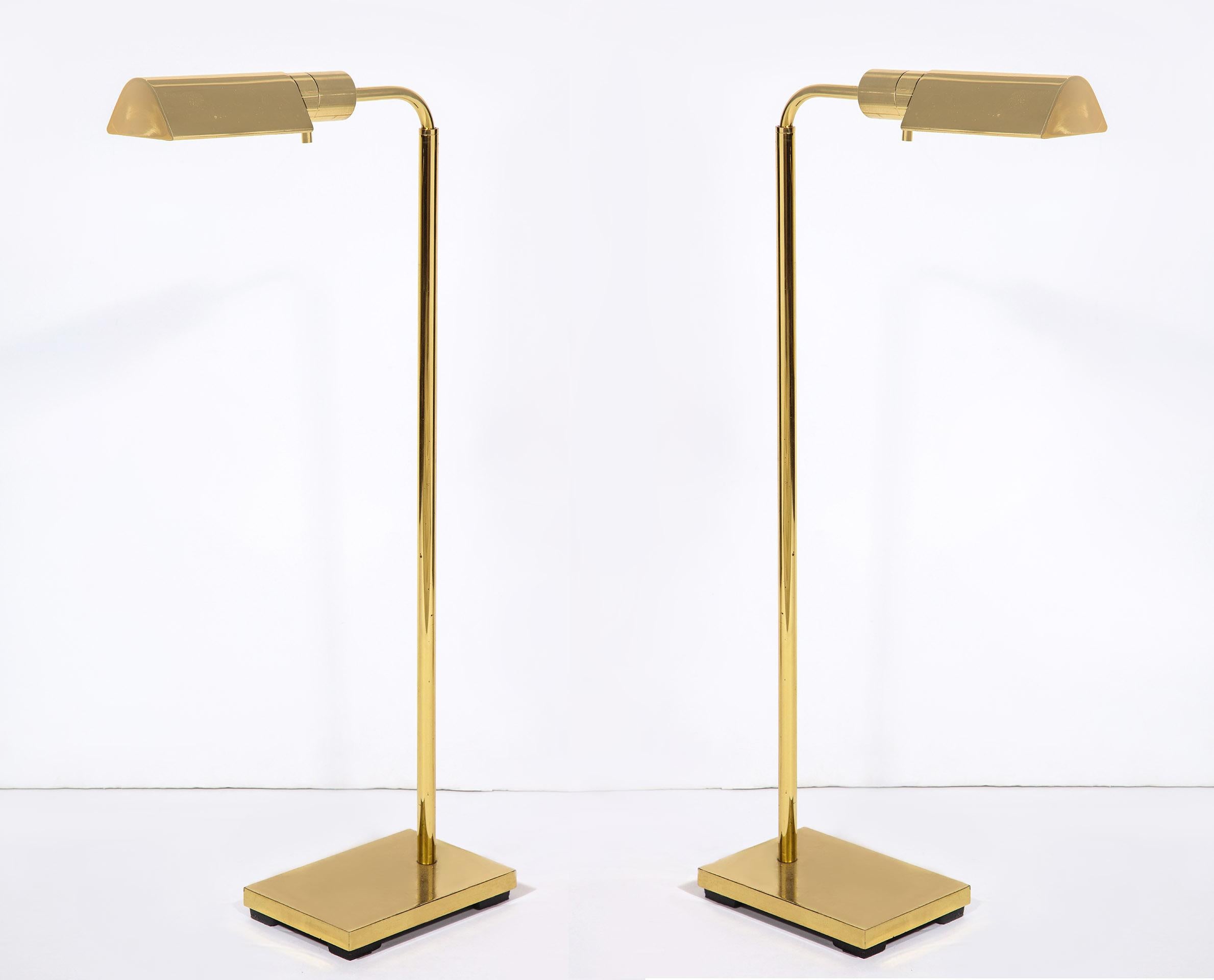 The swivel floor lamp with rounded V form shades with a rectangular shaped base. Minimum height, 36