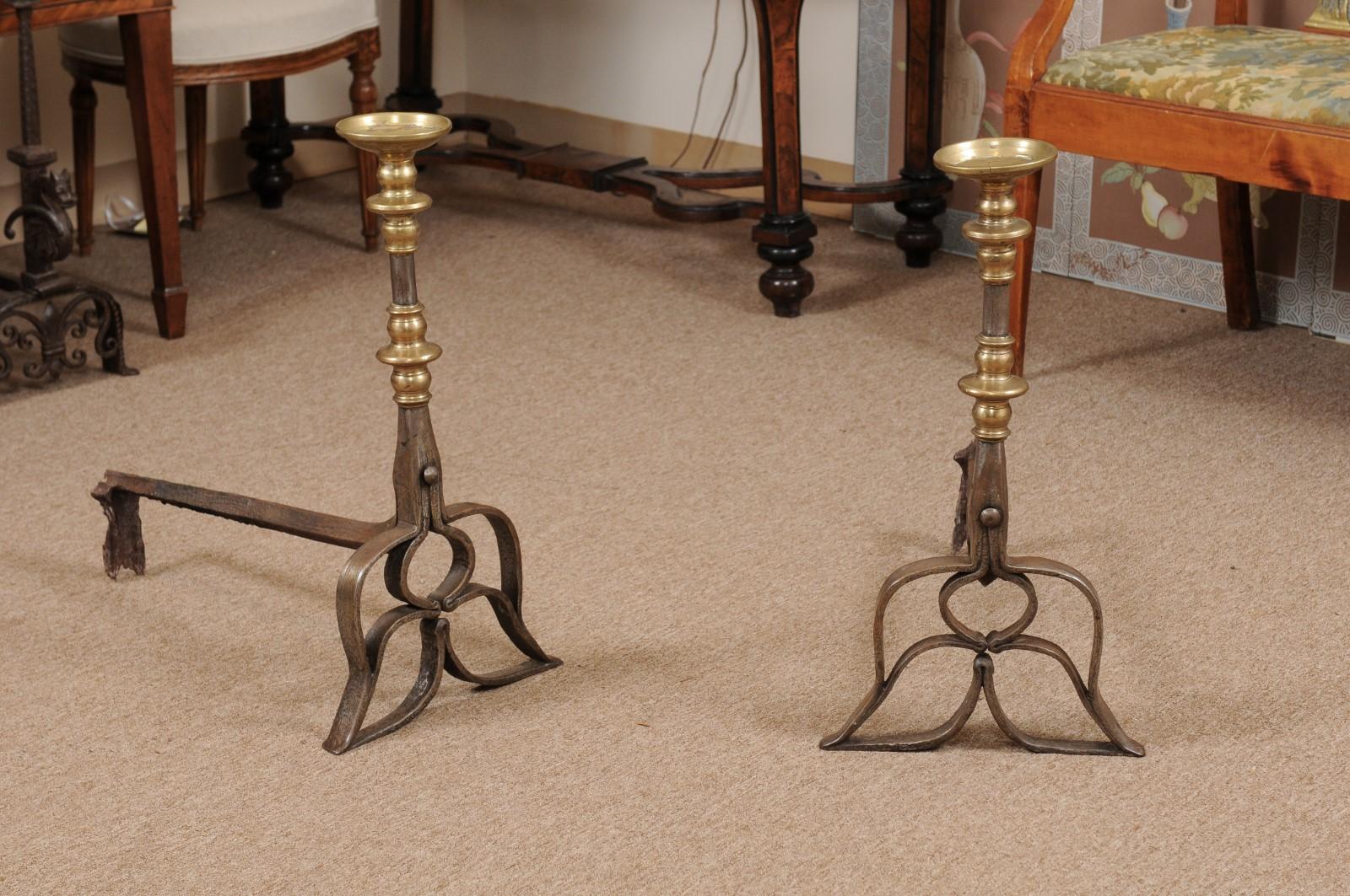 Pair of 16th century steel andirons with brass accents.