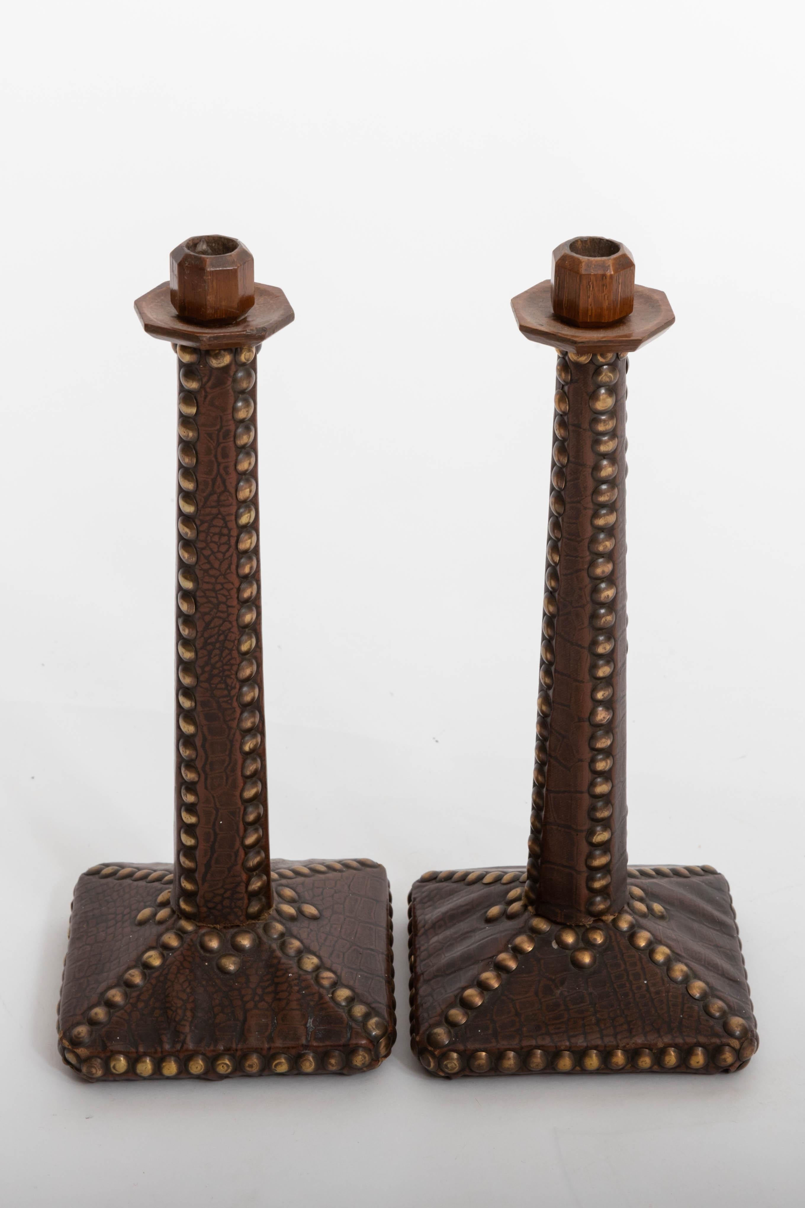 Pair of unusual leather candle sticks.