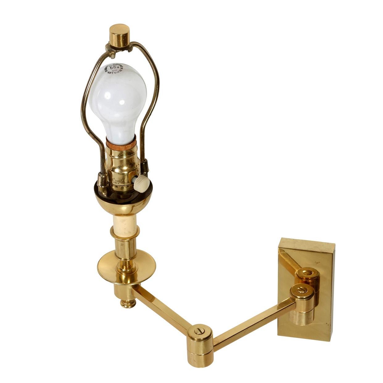 A pair of classic brass swing arm wall lights with a rectangular back plate from a high quality lighting manufacturer.  The simplicity of the design blends with traditional design or contemporary styles.  The light when fully extended measures14