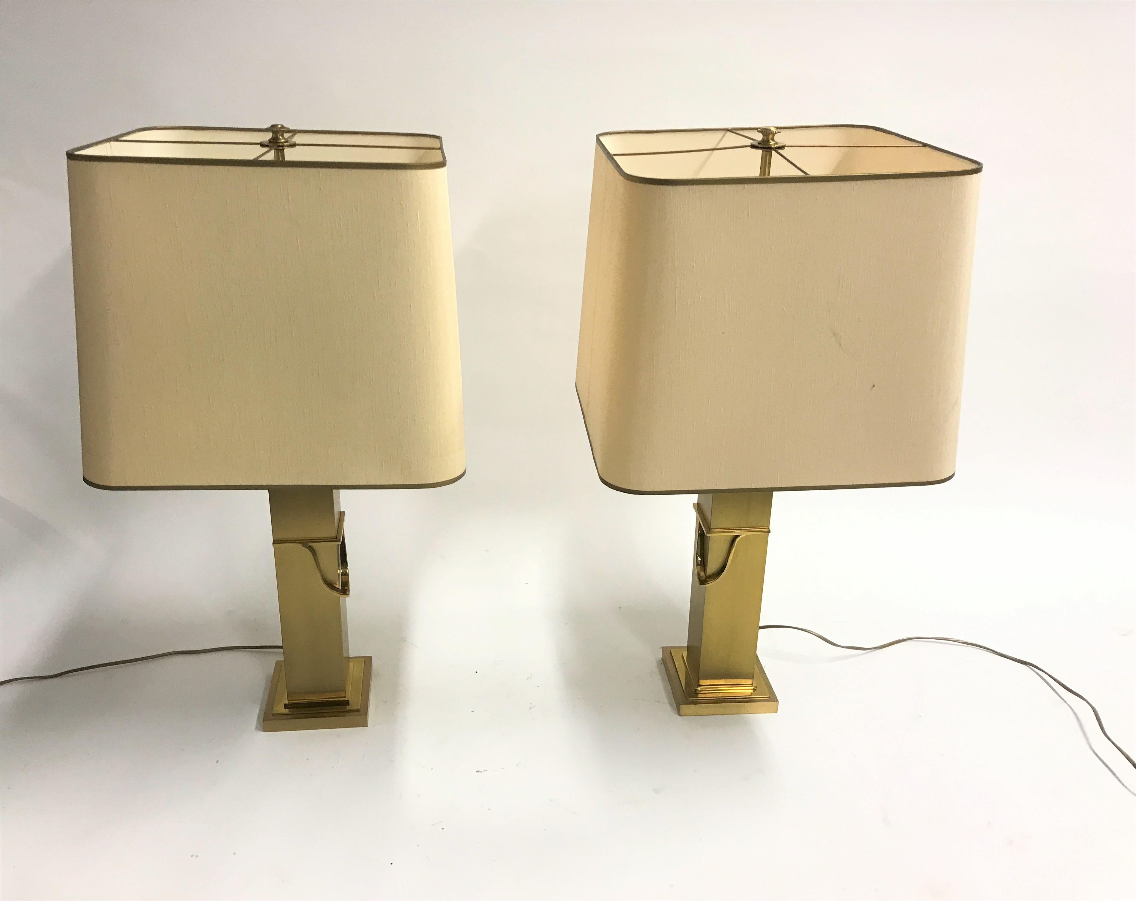 Pair of beautiful brass table lamp by Belgochrom.

These seventies glamour lamps are simple, but elegant and come with their original lamp shade.

They have two E26/E27 light points with the original metal pulling cords.

Tested and ready to