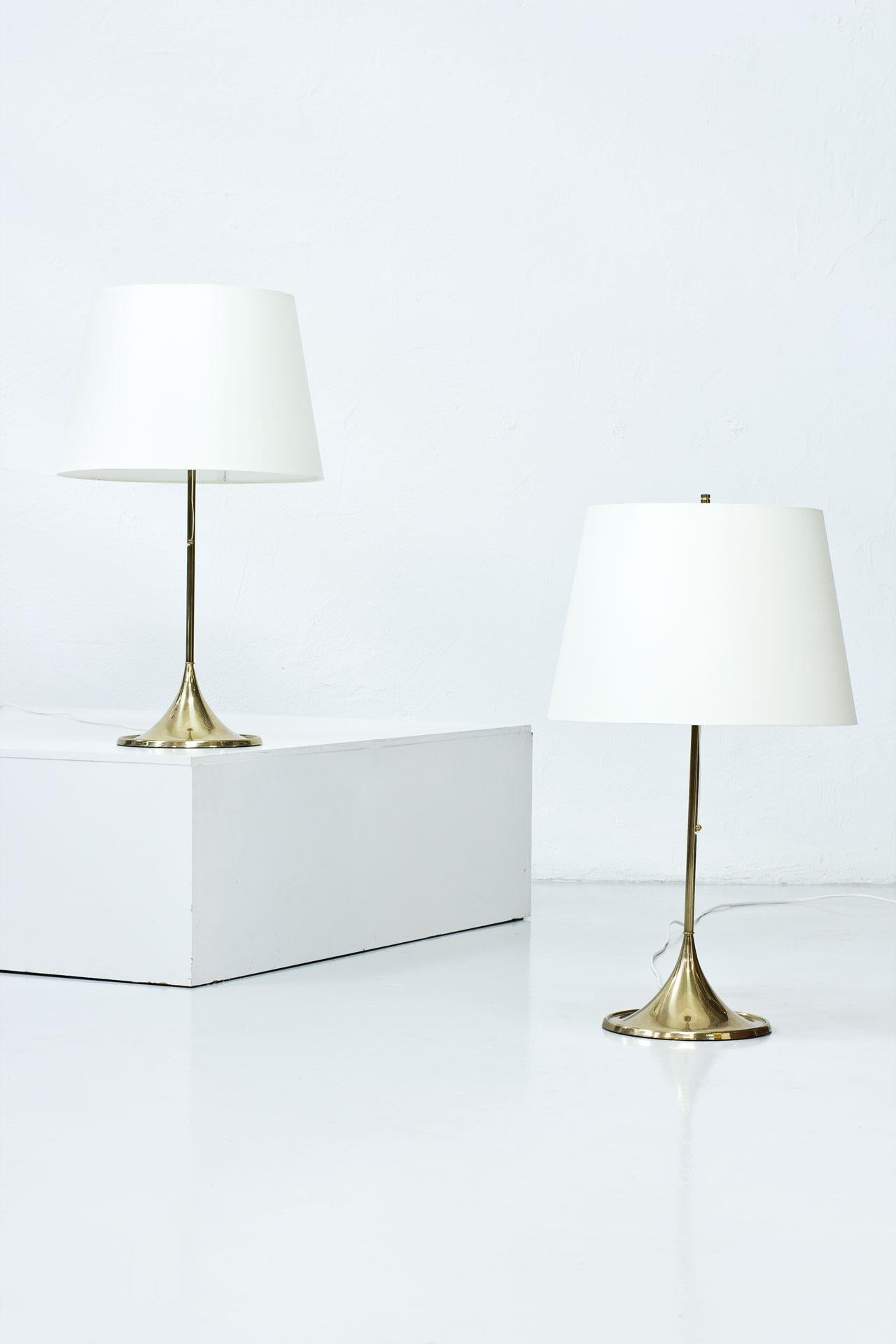 Pair of table lamps model B-024 designed by Alf Svensson and Yngvar Sandström,
(Studio S-Design) manufactured by Bergboms in Sweden during the 1960s. 
Polished brass stem, cast iron base, acrylic top diffuser and shades newly redone (handmade in