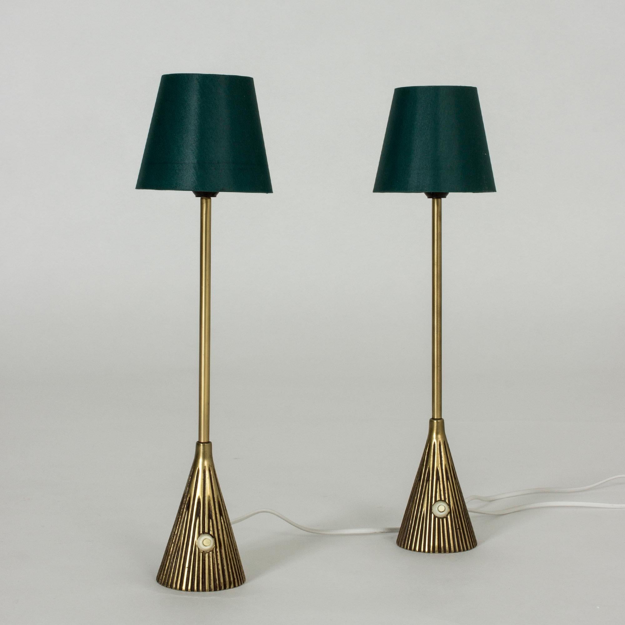 Pair of cool brass table lamps by Sonja Katzin. Slender design with conical bases with a relief pattern of stripes that gives an impression of movement.