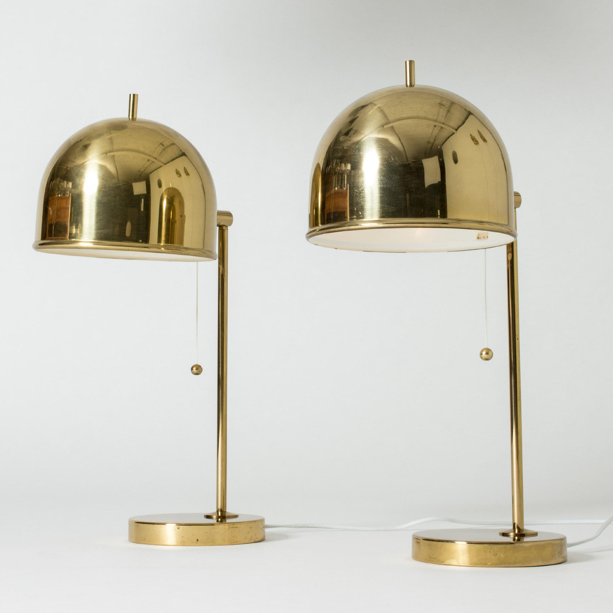 Pair of brass table lamps from Bergboms in a design that combines the generous arches of the shades with strict lines. The little tips on the tops of the shades add a whimsical look.