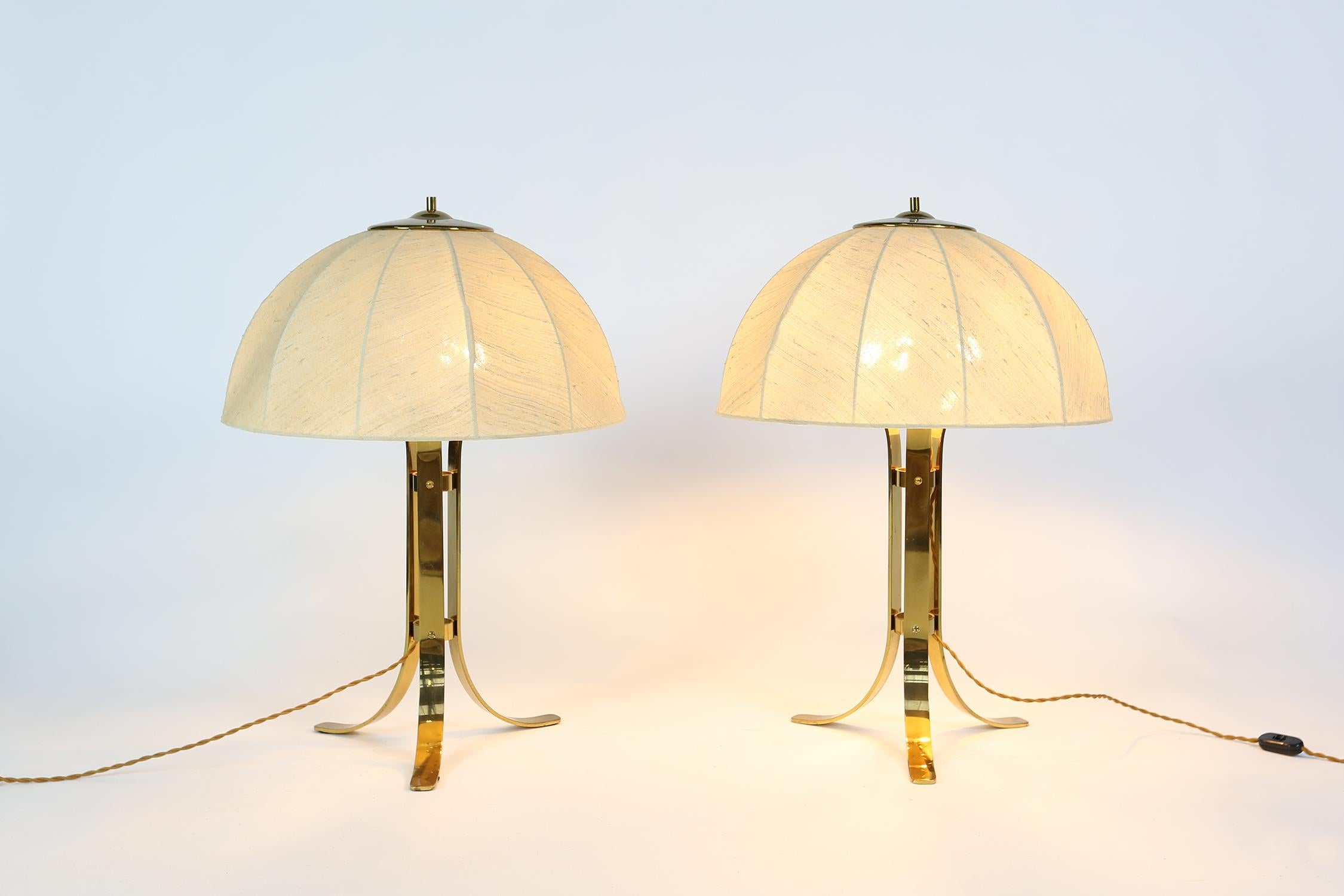 A wonderful pair of Italian table lamps, circa 1960. Beautifully aged silk lampshades on a brass base, compliment the newly re-wired cording.
Each lamp has 3 lightbulbs.