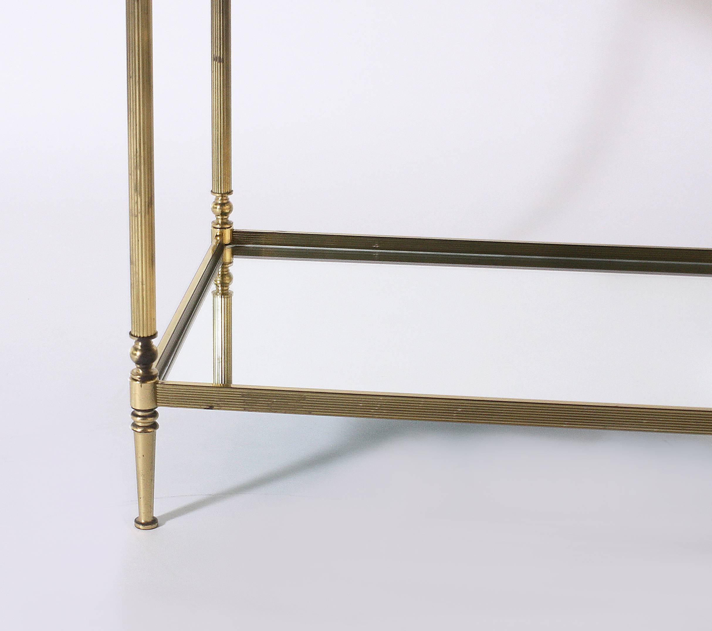 Pair of brass tables with mirror tops in the style of Maison Jansen, circa 1950.
 