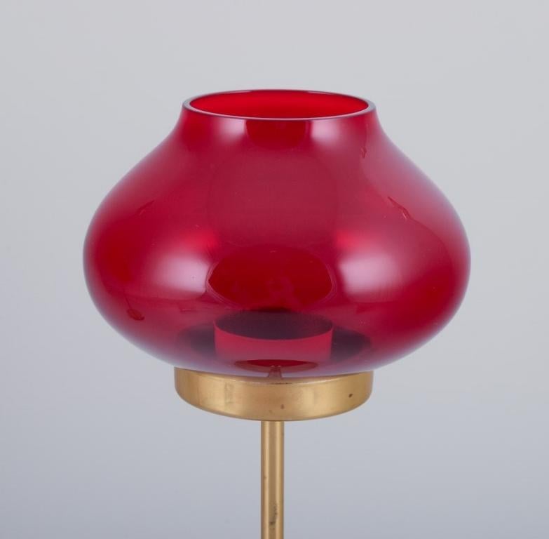 A pair of brass tealight holders in wine-red glass shades.
Swedish design.
Approximately from the 1970s/1980s.
Perfect condition.
Dimensions: H 26.5 cm x D 12.0 cm (glass).