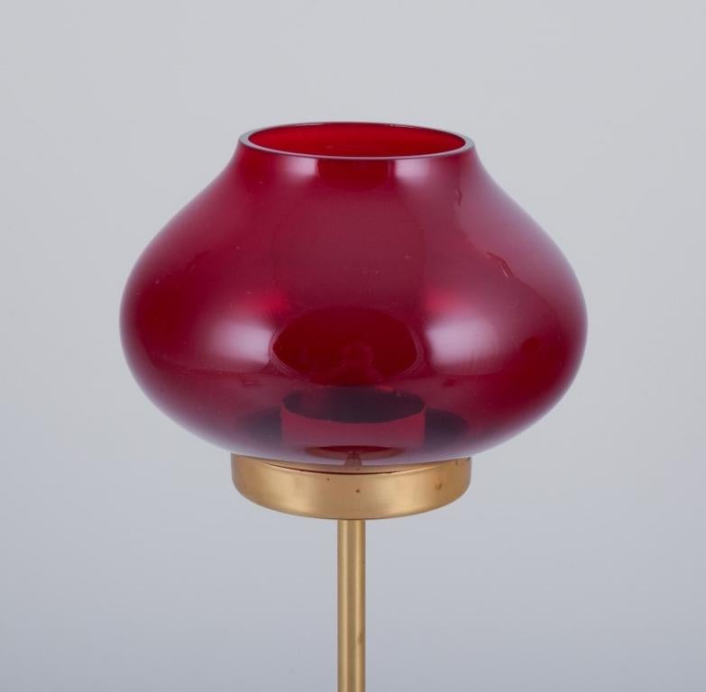 Scandinavian Modern Pair of brass tealight holders in wine-red glass shades. Swedish design.  For Sale