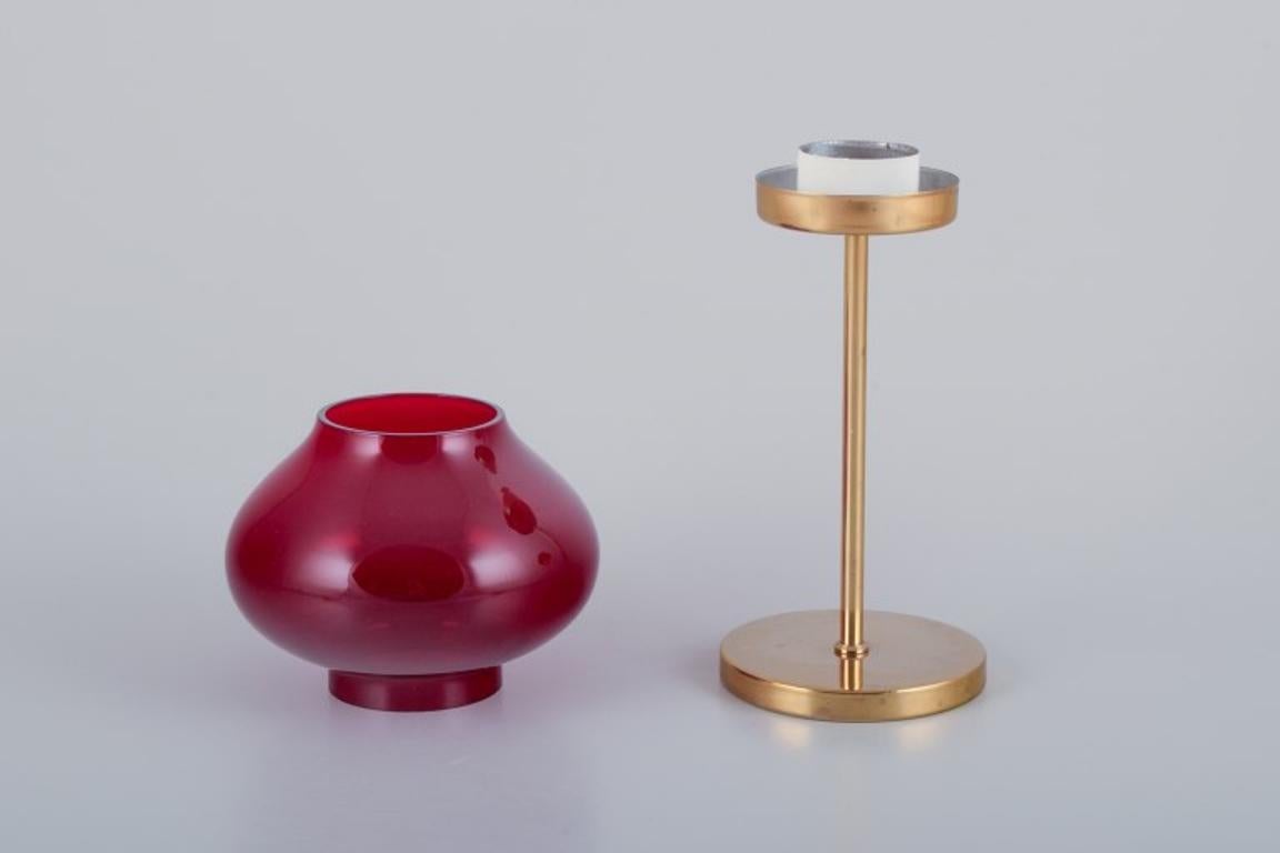 Pair of brass tealight holders in wine-red glass shades. Swedish design.  In Excellent Condition For Sale In Copenhagen, DK