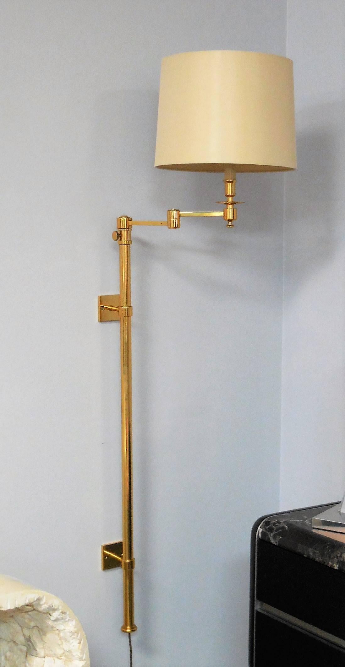 A pair of telescopic sconces with articulated extendable arms. Solid brass construction. New silk shades. Each sconce extends from 51