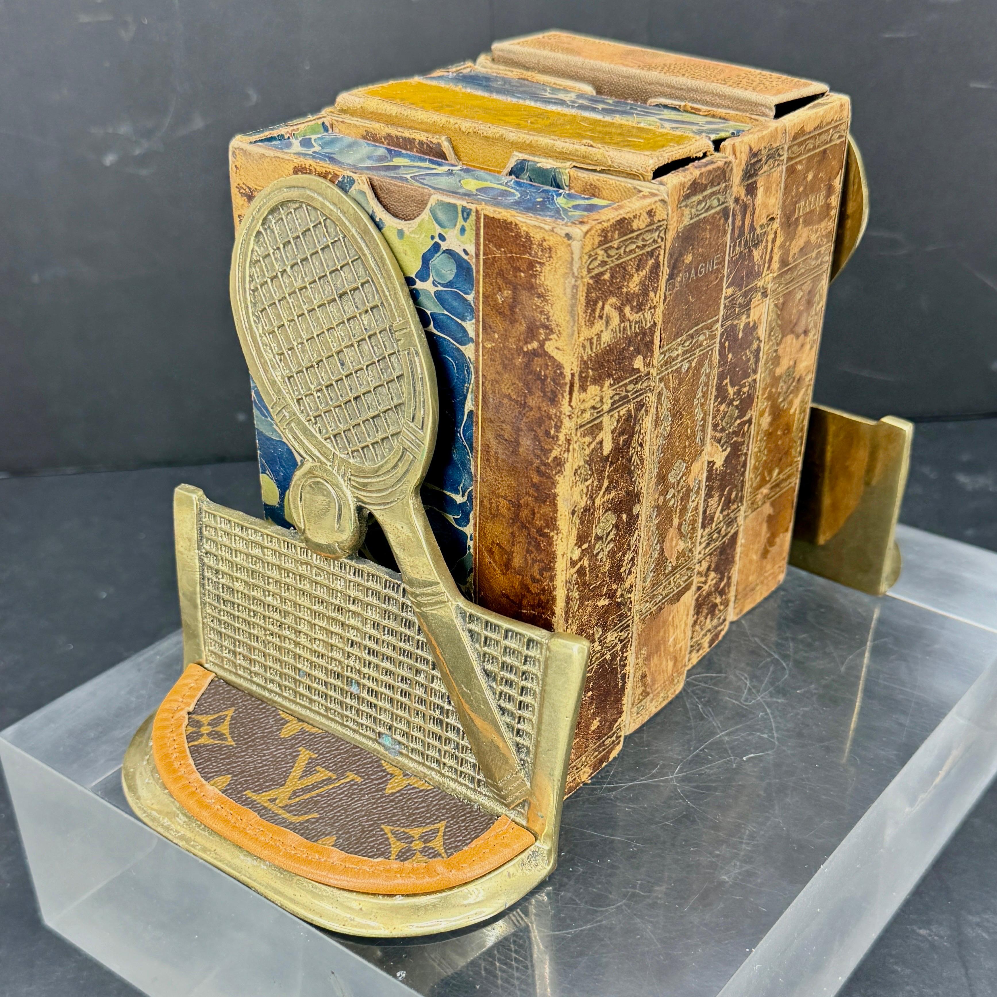 This Mid-Century set of Tennis and Louis Vuitton themed bookends are absolutely one of a kind and most certainly would accentuate your home on a bookcase, table, or desk. This pair, with LV leather, makes a fantastic statement piece that you could