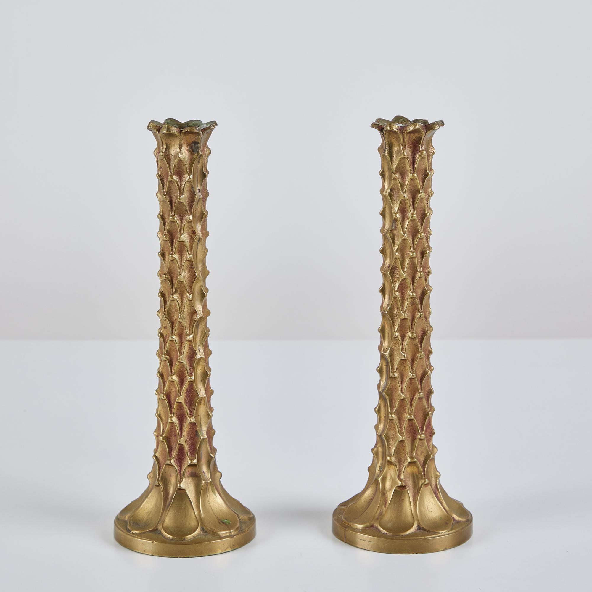 Pair of solid brass candlesticks. The pair of beautifully patinated candlesticks feature palm tree like textured stems, and round bases.

Dimensions
3.5